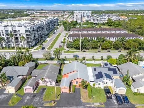 12801 SW 248th Terrace, Homestead, FL 33032 Aerial perspective of residential lots featuring asphalt driveways, attached single-car garages, hip-style roofing, and integrated solar panel systems