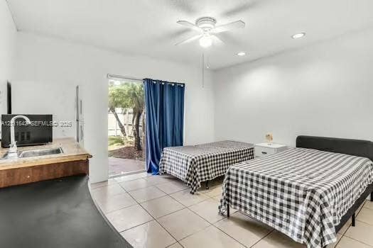 12801 SW 248th Terrace, Homestead, FL 33032 Interior featuring ceramic tile flooring, recessed lighting, ceiling fan, and a wet bar with a stainless steel faucet and sink