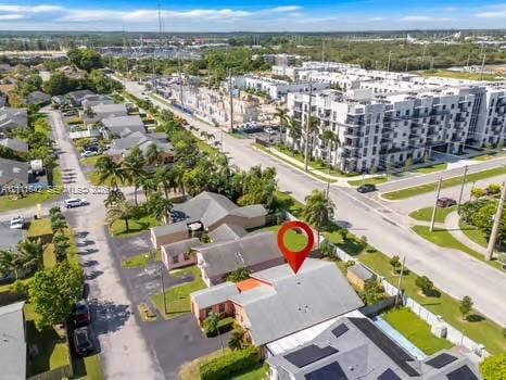 12801 SW 248th Terrace, Homestead, FL 33032 Aerial perspective of a multi-structure property featuring asphalt-paved off-street parking, a shingled roof, and established tropical landscaping