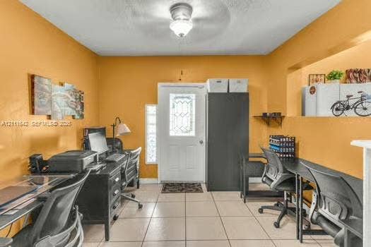12801 SW 248th Terrace, Homestead, FL 33032 Entryway featuring large-format tile flooring, a glass-paneled exterior door, a central ceiling-mounted light fixture, and a built-in recessed wall niche