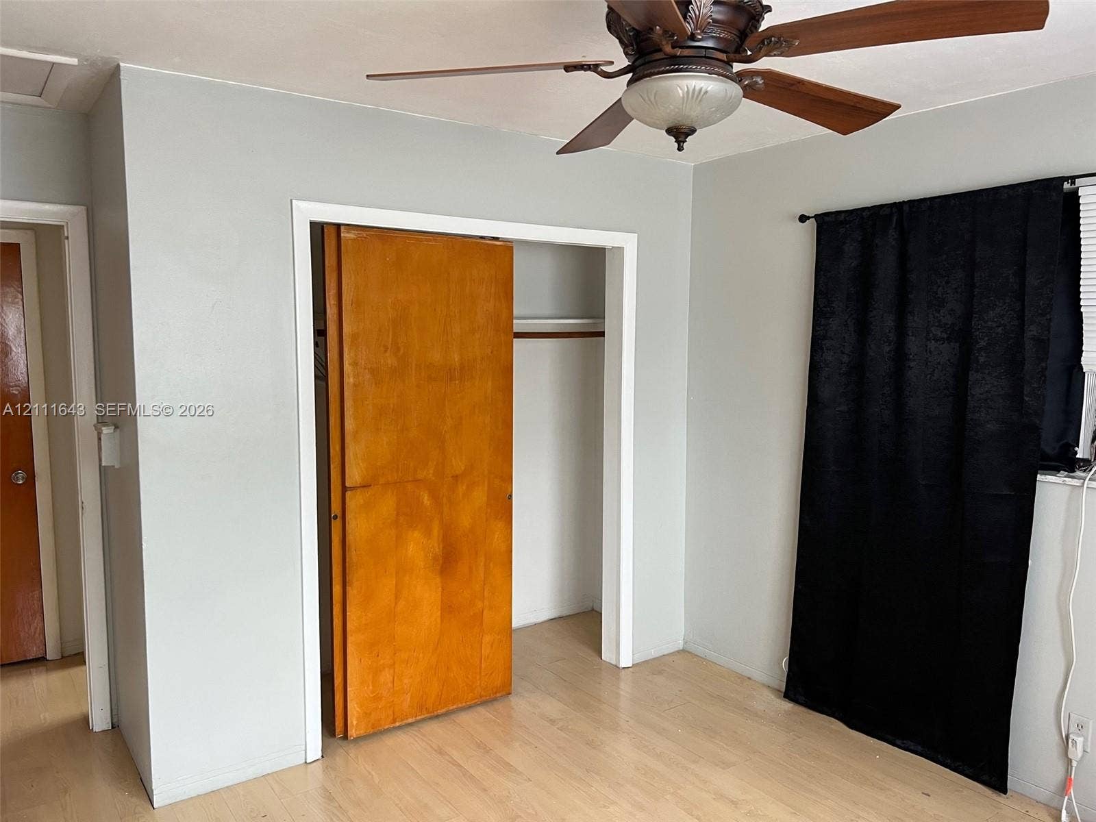 4841 SW 45th Avenue, #1, Hollywood, Hollywood, FL 33314 Wood-finish flooring, ceiling fan with integrated lighting, and natural wood closet door