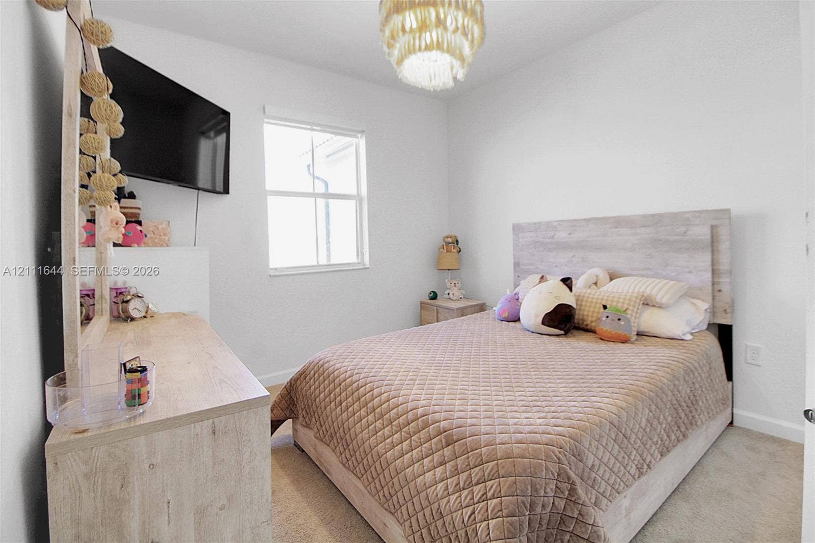 2873 SE 24th Avenue, Homestead, FL 33035 Neutral-toned interior space featuring wall-to-wall carpeting, a single-hung window, and a ceiling-mounted light fixture