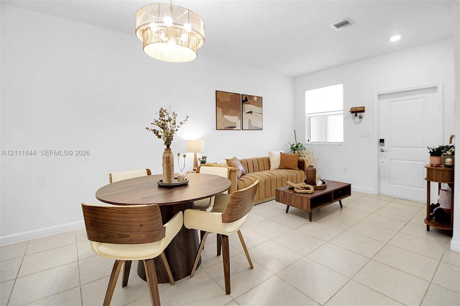 2873 SE 24th Avenue, Homestead, FL 33035 Neutral ceramic tile flooring, multi-tiered drum pendant lighting, and a single-panel interior door