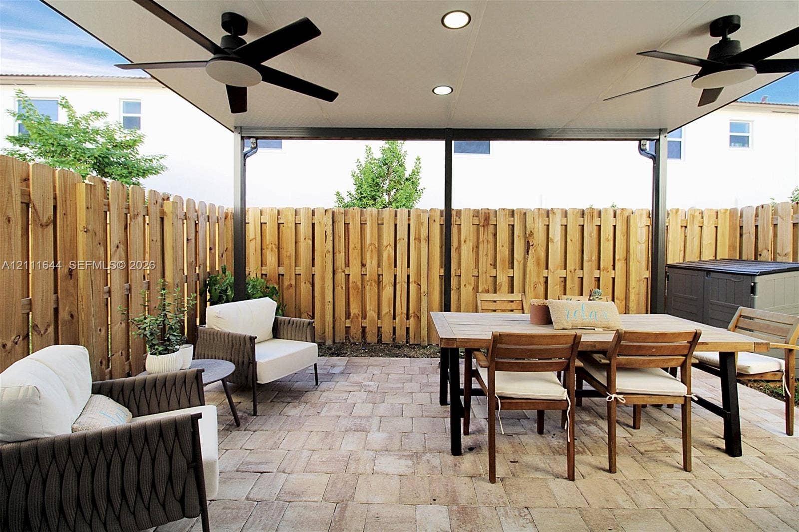 2873 SE 24th Avenue, Homestead, FL 33035 Covered patio featuring a paver surface, recessed lighting, two ceiling fans, and a wood privacy fence