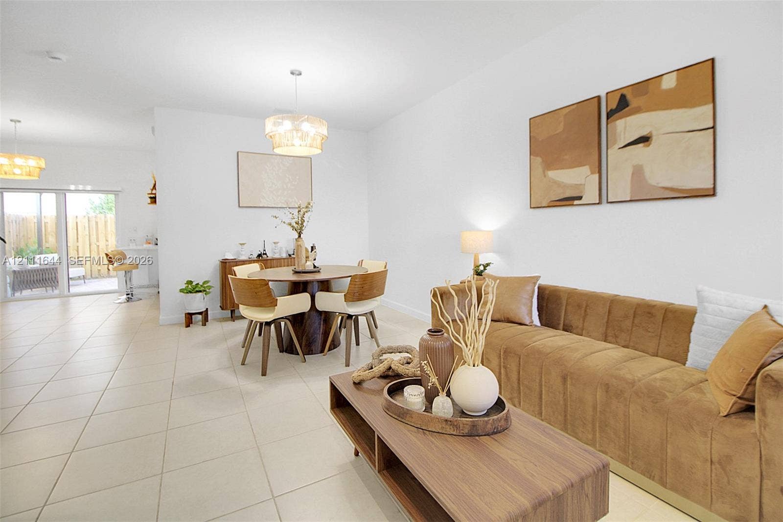 2873 SE 24th Avenue, Homestead, FL 33035 Open-concept interior featuring oversized tile flooring, recessed lighting, decorative tiered pendant fixtures, and a large sliding glass door