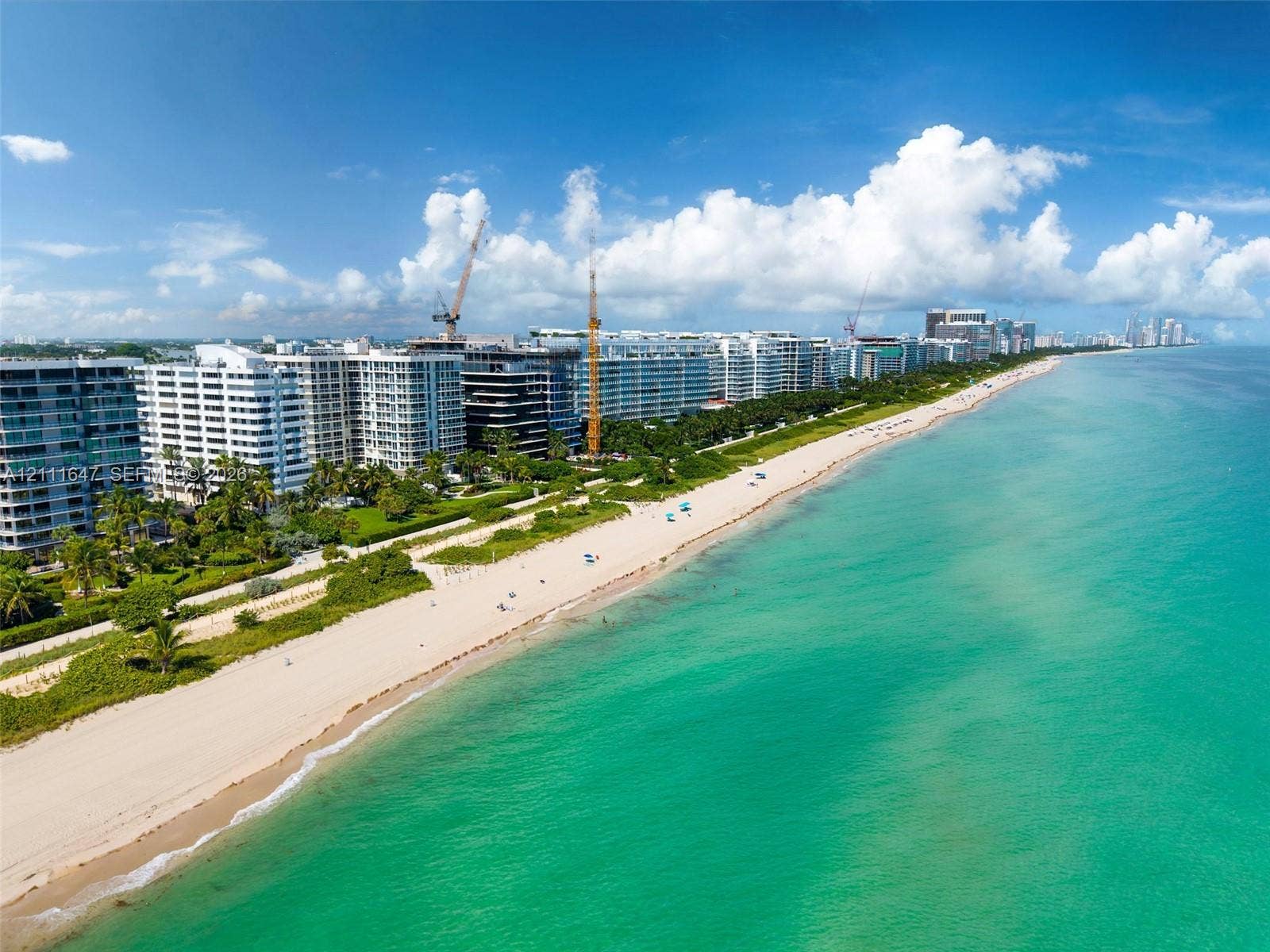 8925 Collins Avenue, #4J, Surfside, FL 33154 Aerial perspective of coastal multi-unit residential architecture featuring direct beach access, sand shoreline, and ocean frontage