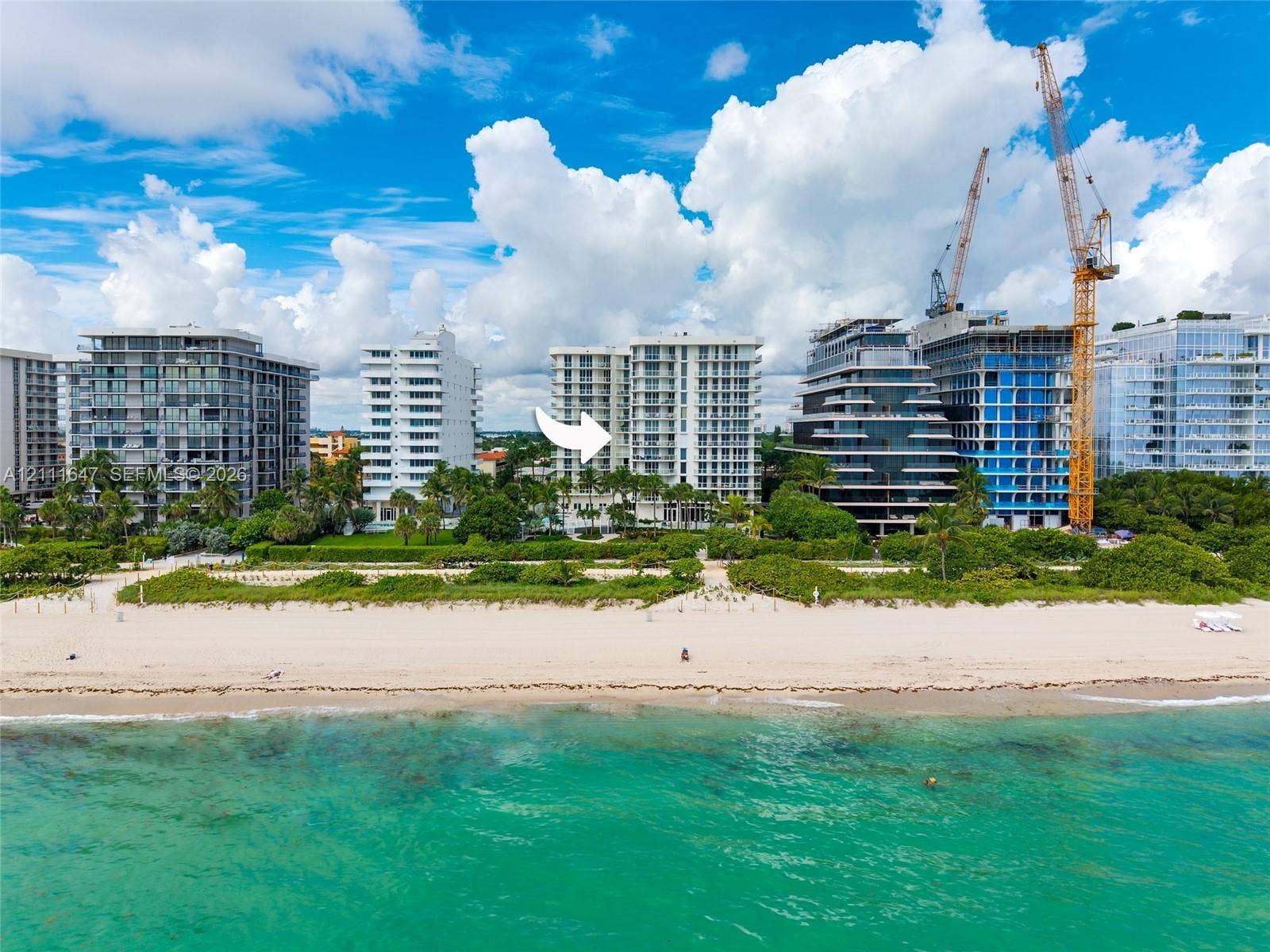 8925 Collins Avenue, #4J, Surfside, FL 33154 High-rise oceanfront building featuring private balconies, floor-to-ceiling glass windows, and direct beach access