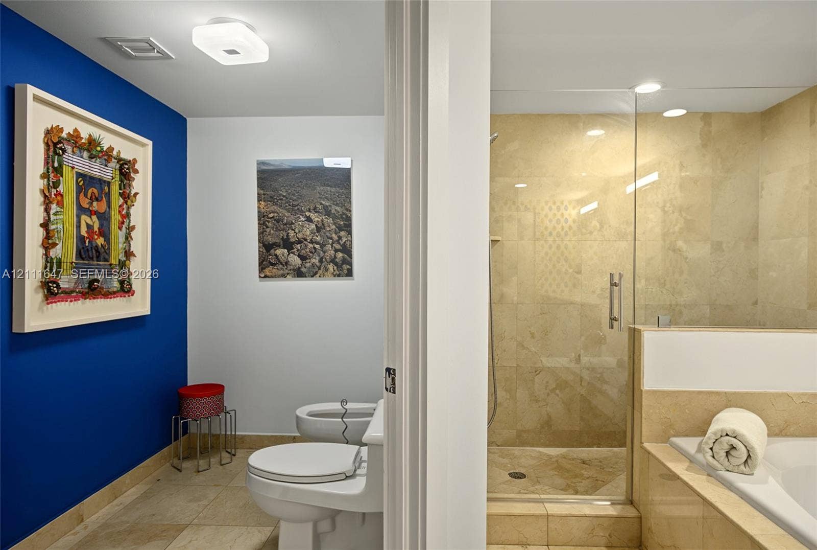8925 Collins Avenue, #4J, Surfside, FL 33154 Full-height glass shower enclosure, stone-tiled flooring, stone wall cladding, built-in soaking tub, and flush-mount lighting