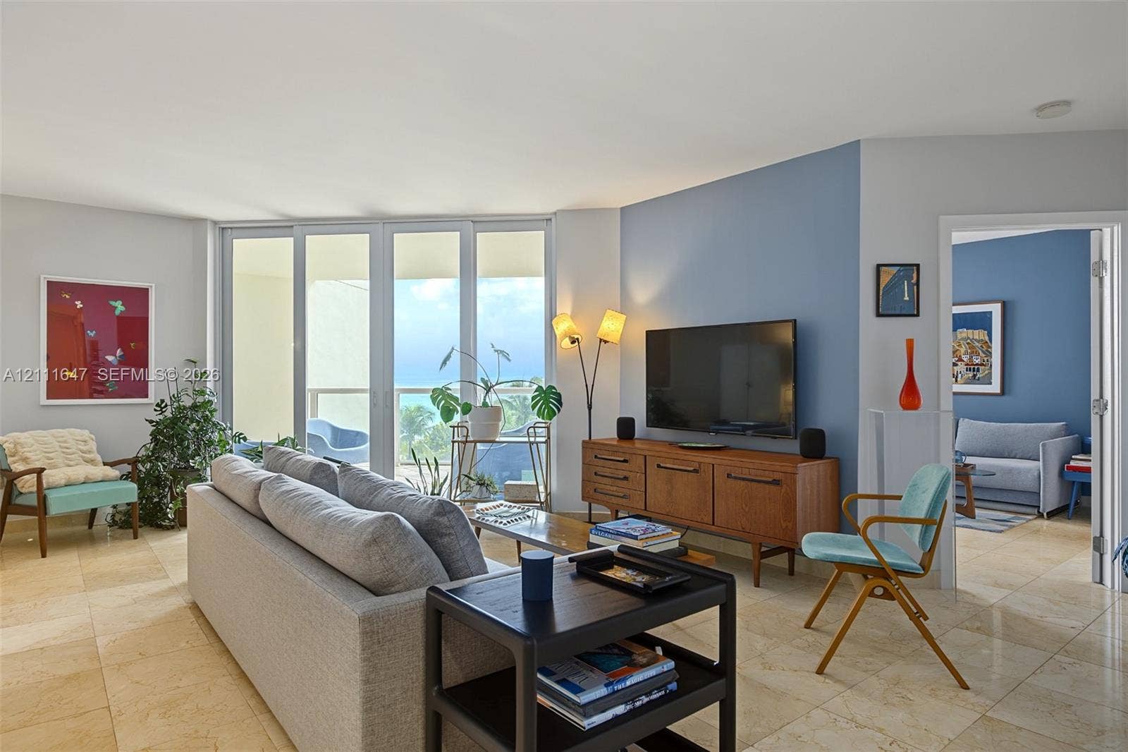 8925 Collins Avenue, #4J, Surfside, FL 33154 Large tile flooring, floor-to-ceiling glass sliding doors, and an accent wall