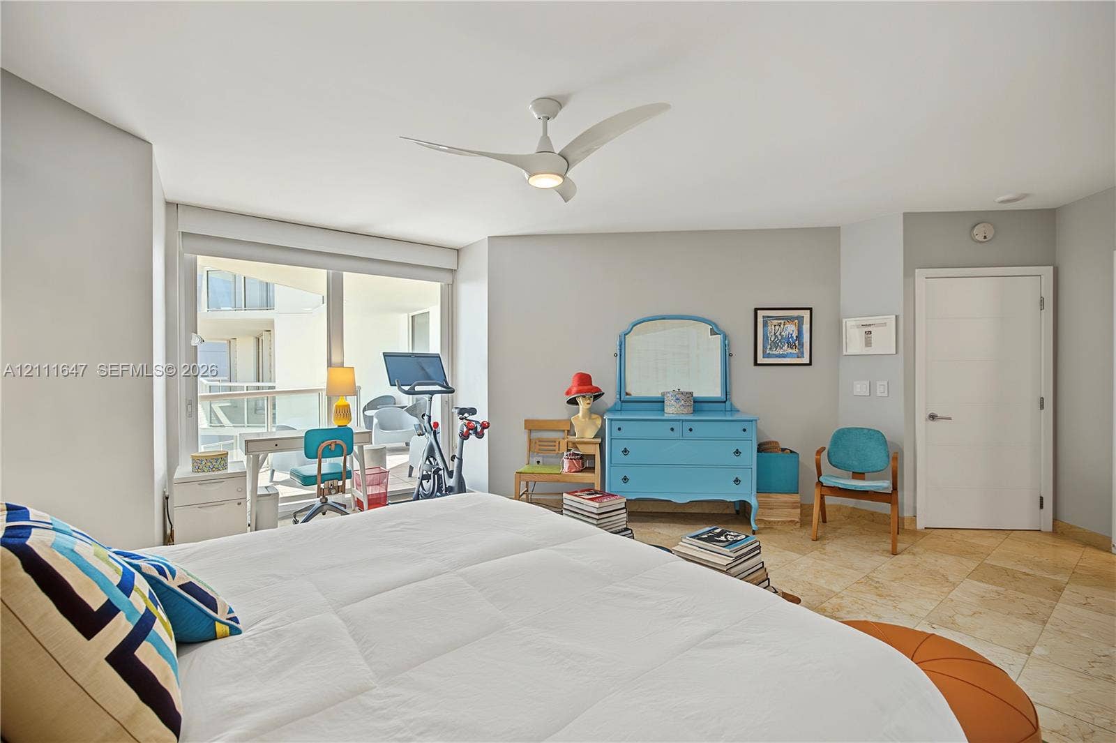8925 Collins Avenue, #4J, Surfside, FL 33154 Natural stone tile flooring, floor-to-ceiling windows, integrated balcony access, and a multi-blade ceiling fan