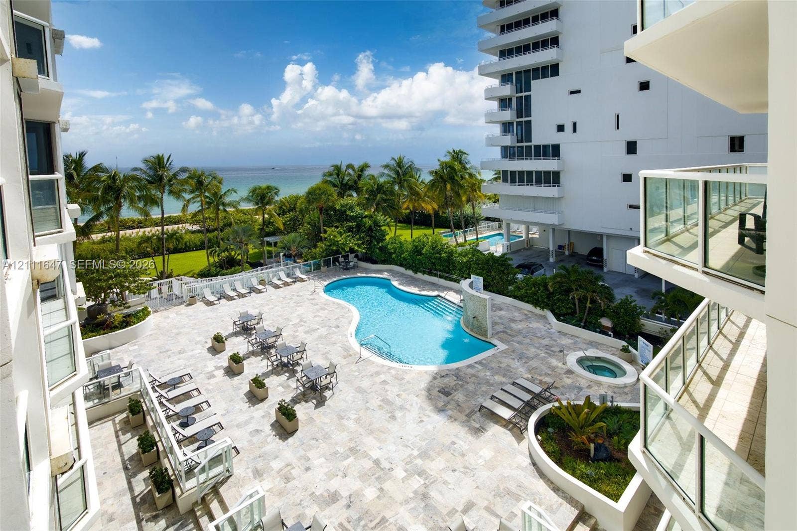 8925 Collins Avenue, #4J, Surfside, FL 33154 Swimming pool with tiered entry, integrated spa, paved sun deck, and ocean horizon