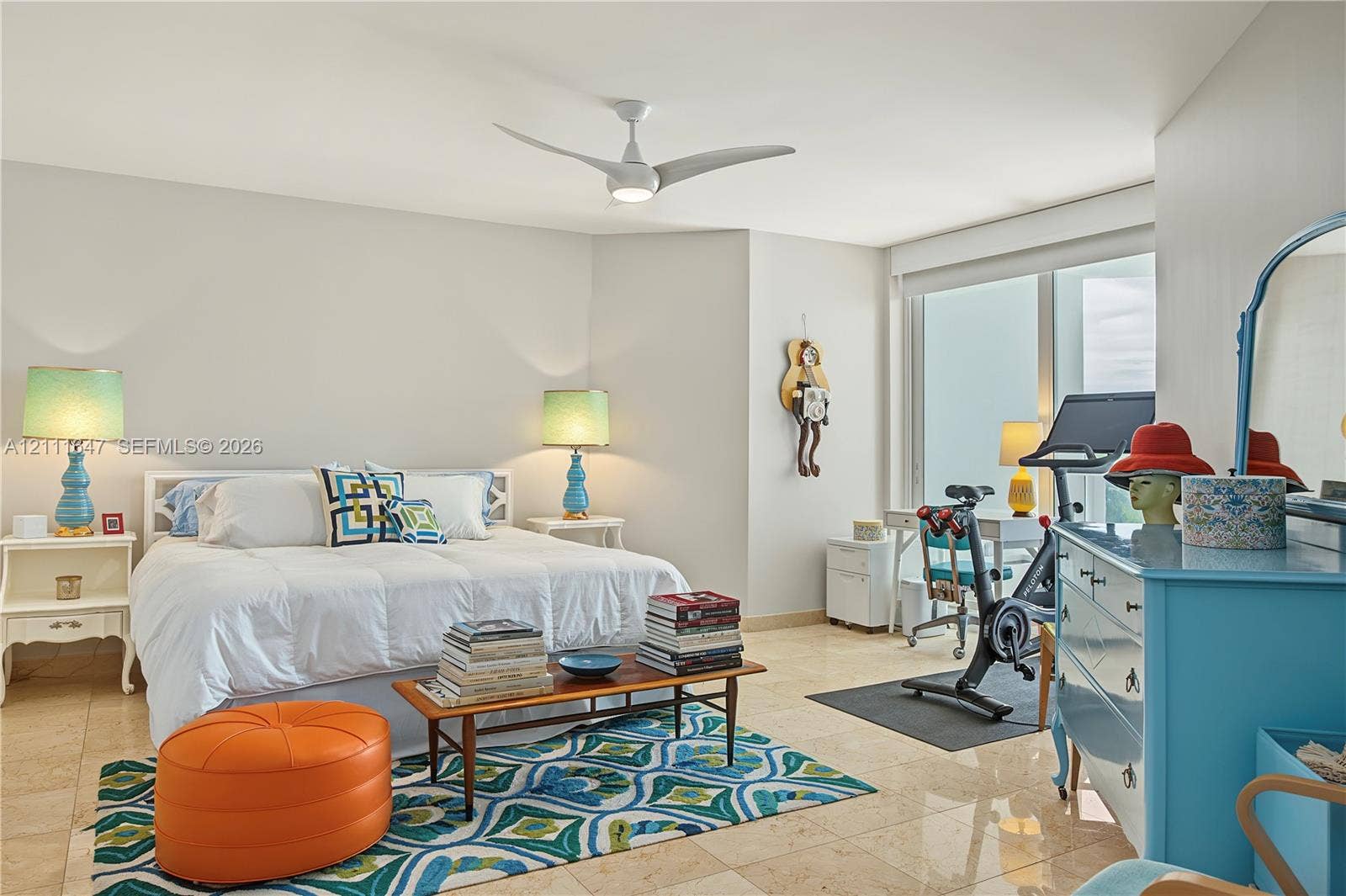 8925 Collins Avenue, #4J, Surfside, FL 33154 Spacious room featuring polished stone flooring, large floor-to-ceiling windows, and a modern three-blade ceiling fan with integrated lighting