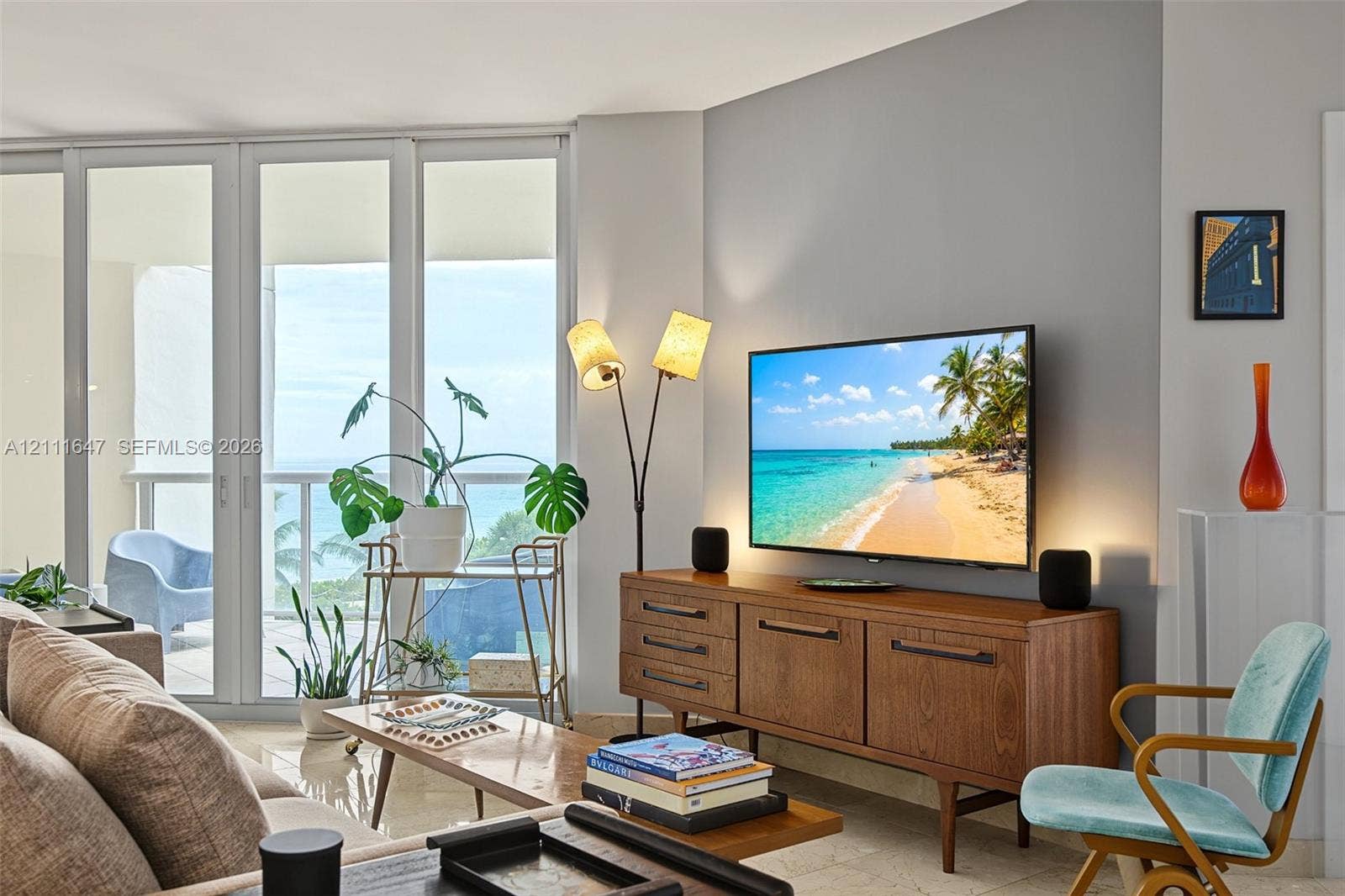 8925 Collins Avenue, #4J, Surfside, FL 33154 Floor-to-ceiling glass sliding doors, neutral tile flooring, and balcony access