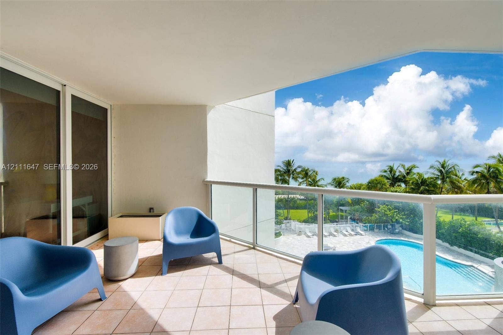 8925 Collins Avenue, #4J, Surfside, FL 33154 Covered balcony featuring tile flooring and a glass-paneled railing