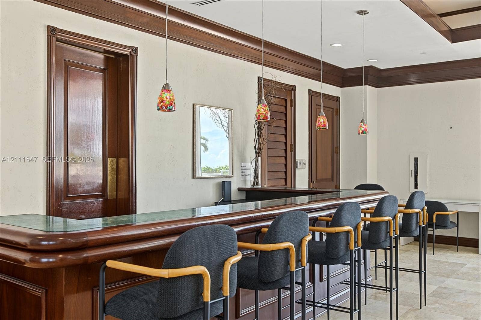 8925 Collins Avenue, #4J, Surfside, FL 33154 Built-in wooden bar with stone countertop, crown molding, paneled doors, recessed lighting, and stone flooring
