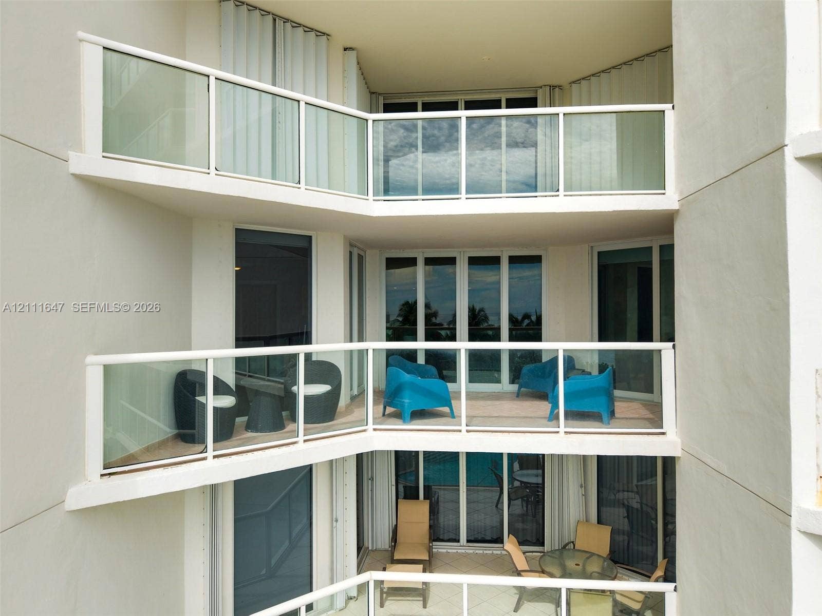 8925 Collins Avenue, #4J, Surfside, FL 33154 Multi-level stacked balconies featuring glass railings and tile flooring