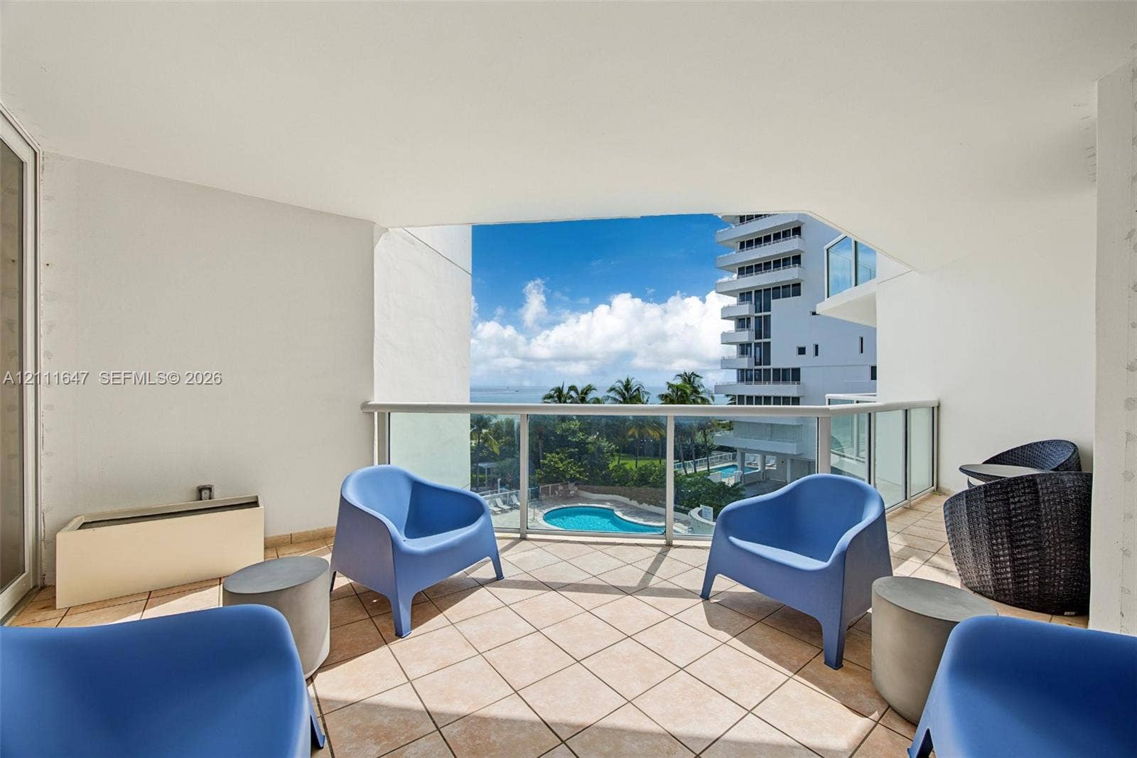 8925 Collins Avenue, #4J, Surfside, FL 33154 Covered balcony featuring tile flooring and a glass-paneled railing