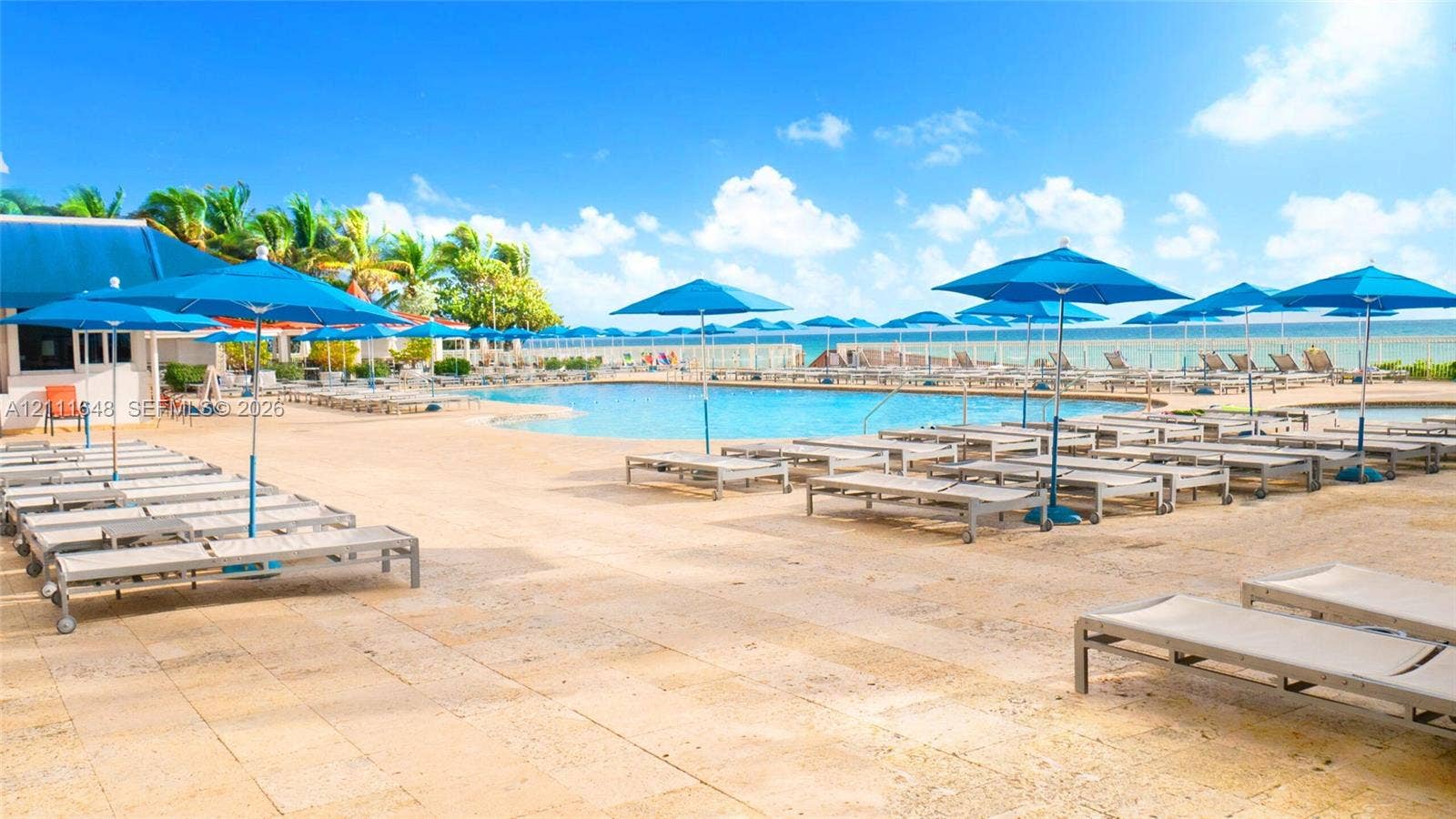 19201 Collins Avenue, #518, Sunny Isles Beach, FL 33160 Swimming pool with natural stone decking, perimeter edge design, and expansive ocean backdrop