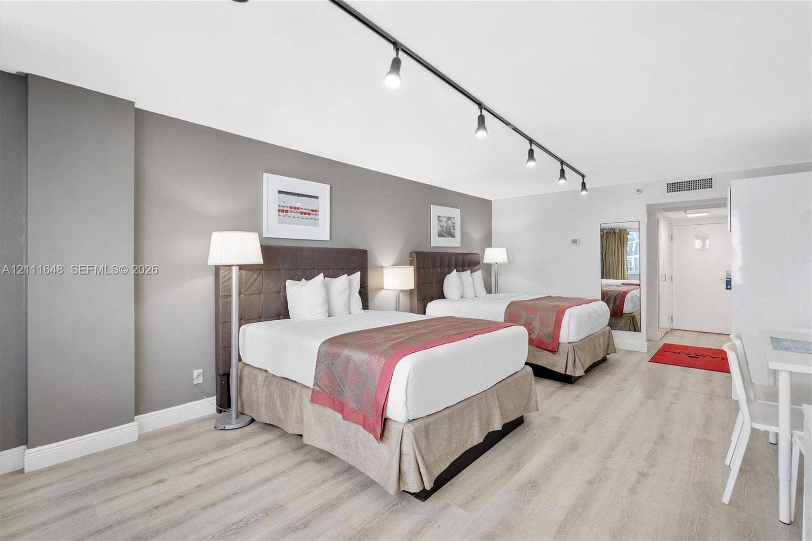19201 Collins Avenue, #518, Sunny Isles Beach, FL 33160 Wood-finish flooring, neutral wall tones, and overhead track lighting