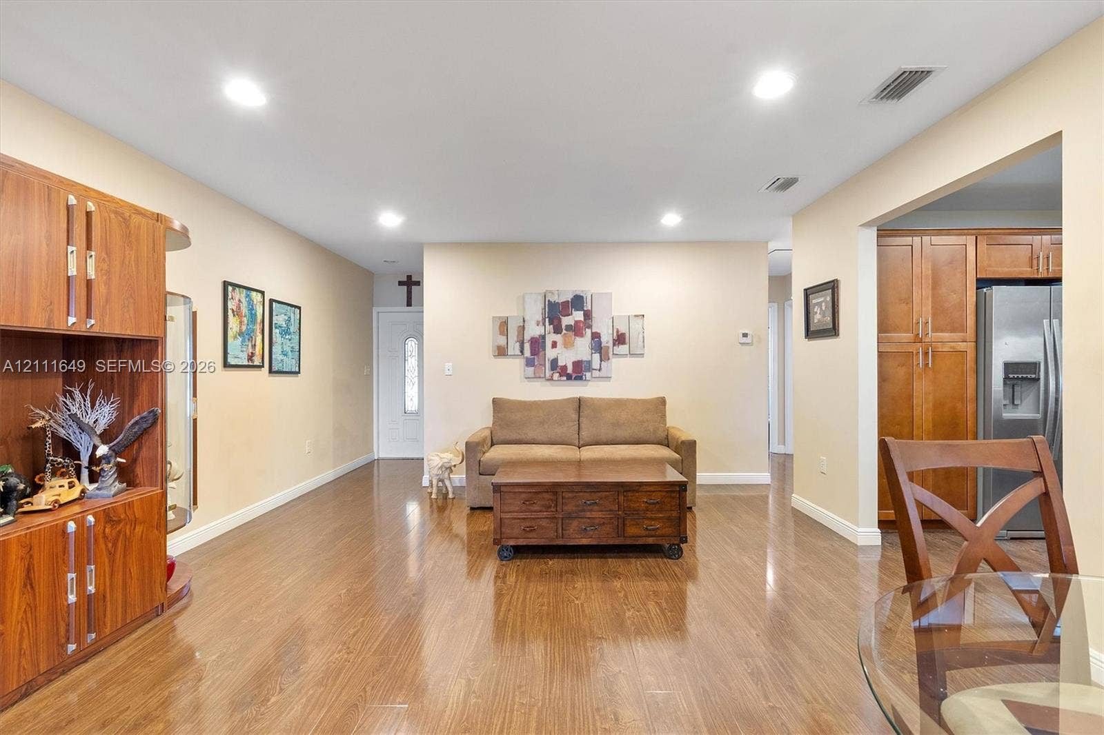 Wood-finish flooring, recessed lighting, and built-in wood cabinetry