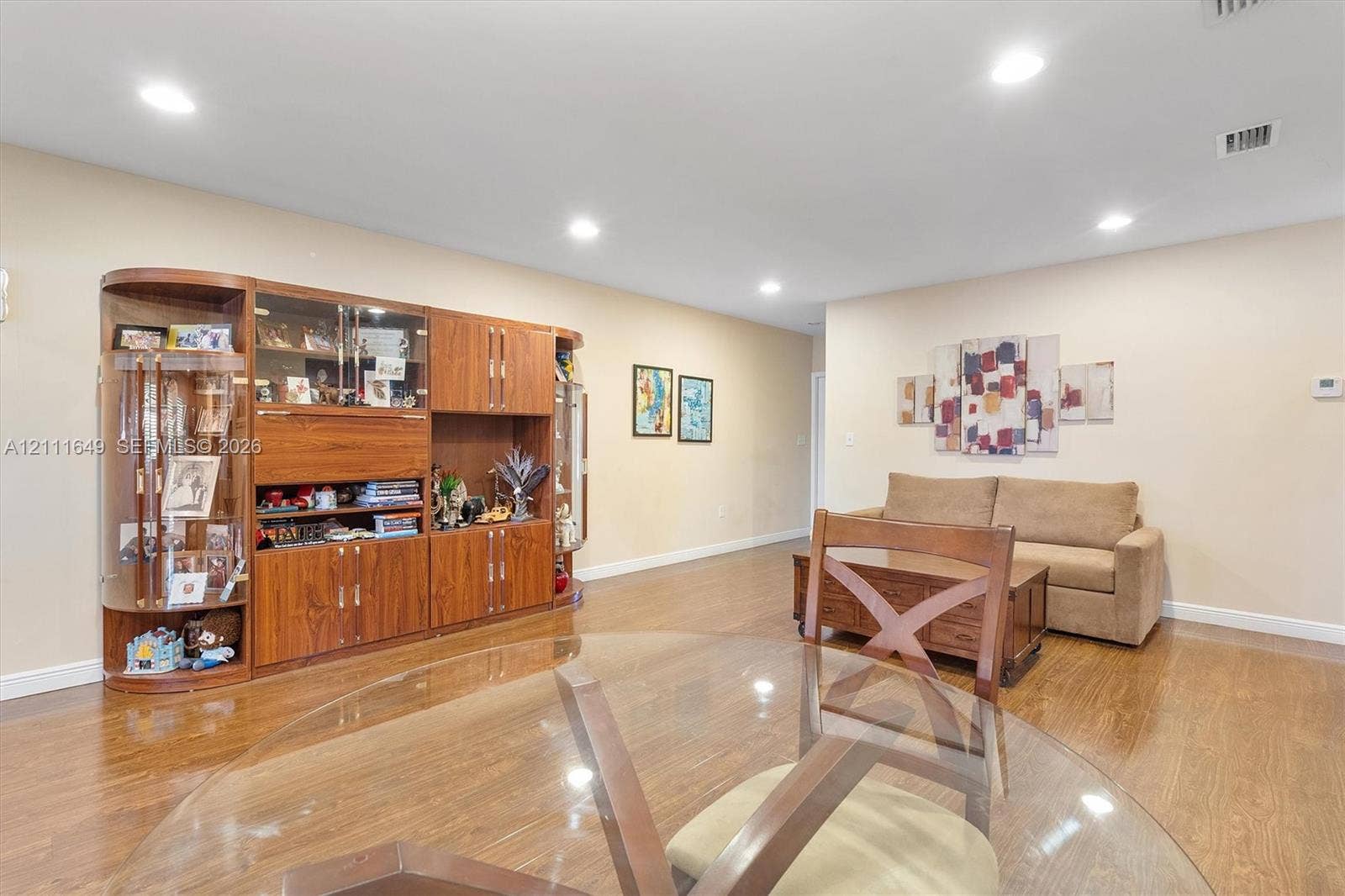 Open-concept space featuring wood-finish flooring and recessed lighting