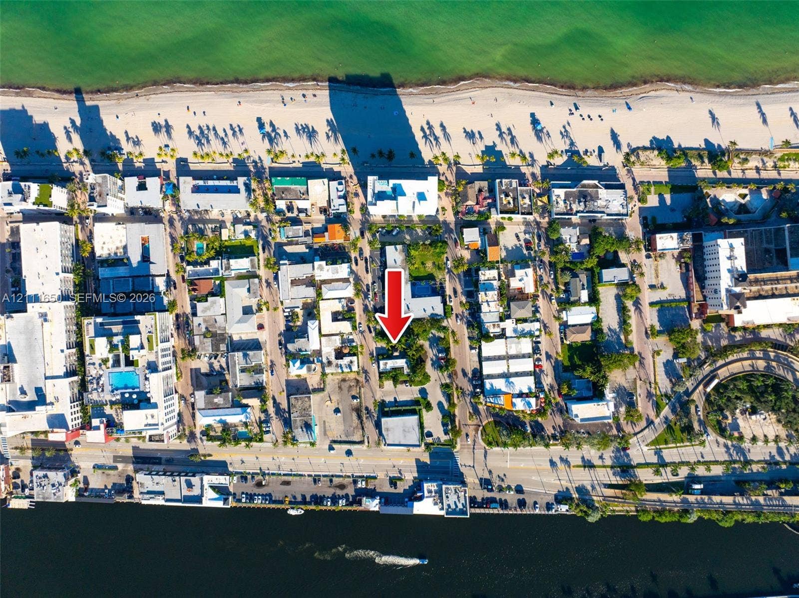 Aerial perspective of coastal property situated between oceanfront beaches and a waterway
