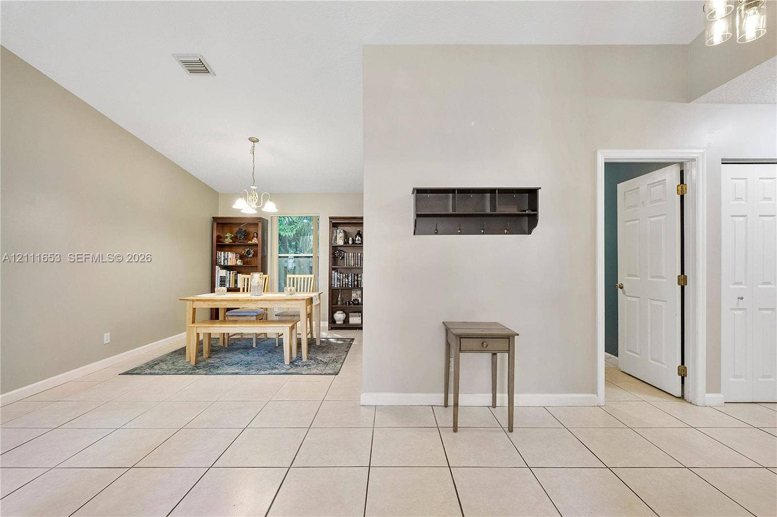 1042 NE 38th Street, Oakland Park, FL 33334 Ceramic tile flooring, vaulted ceilings, and a built-in wall-mounted coat rack