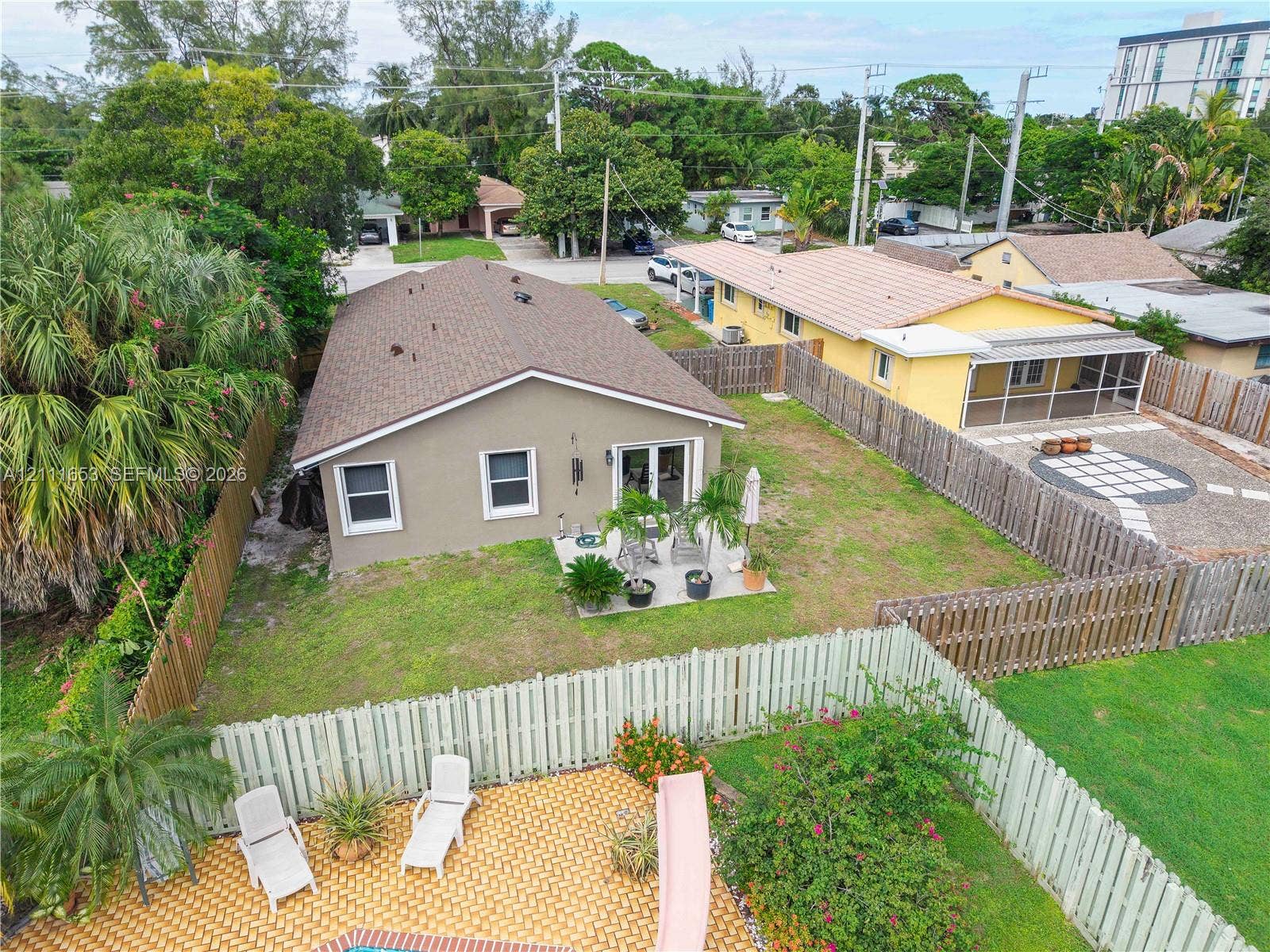 1042 NE 38th Street, Oakland Park, FL 33334 Fenced backyard featuring a concrete patio, enough room to add an in-ground pool