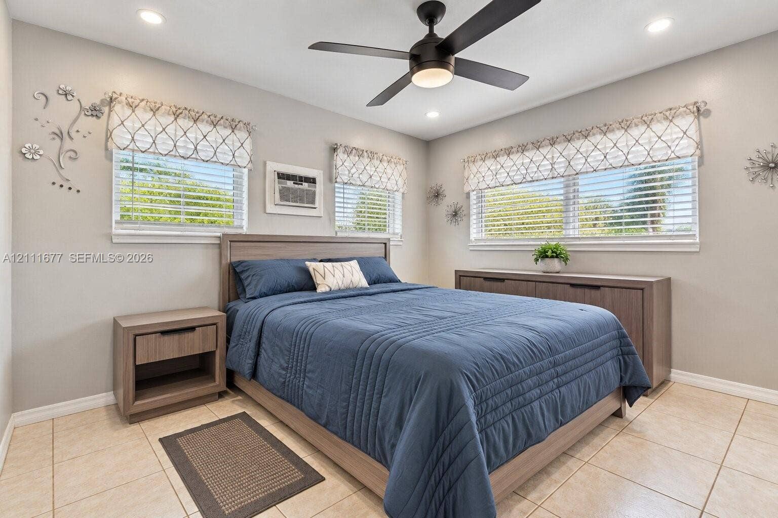 1921 Acapulco Drive, Miramar, FL 33023 Neutral-toned room featuring large-format tile flooring, recessed ceiling lighting, and a dark-finish ceiling fan with an integrated light fixture