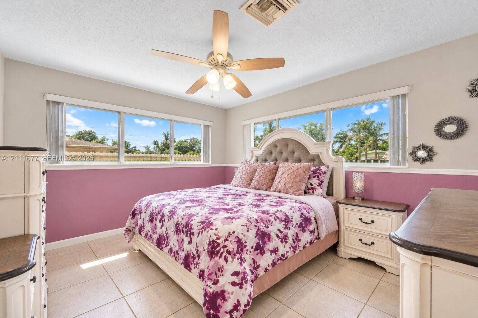1921 Acapulco Drive, Miramar, FL 33023 Neutral wall finish with wainscoting, ceramic tile flooring, and multi-light ceiling fan