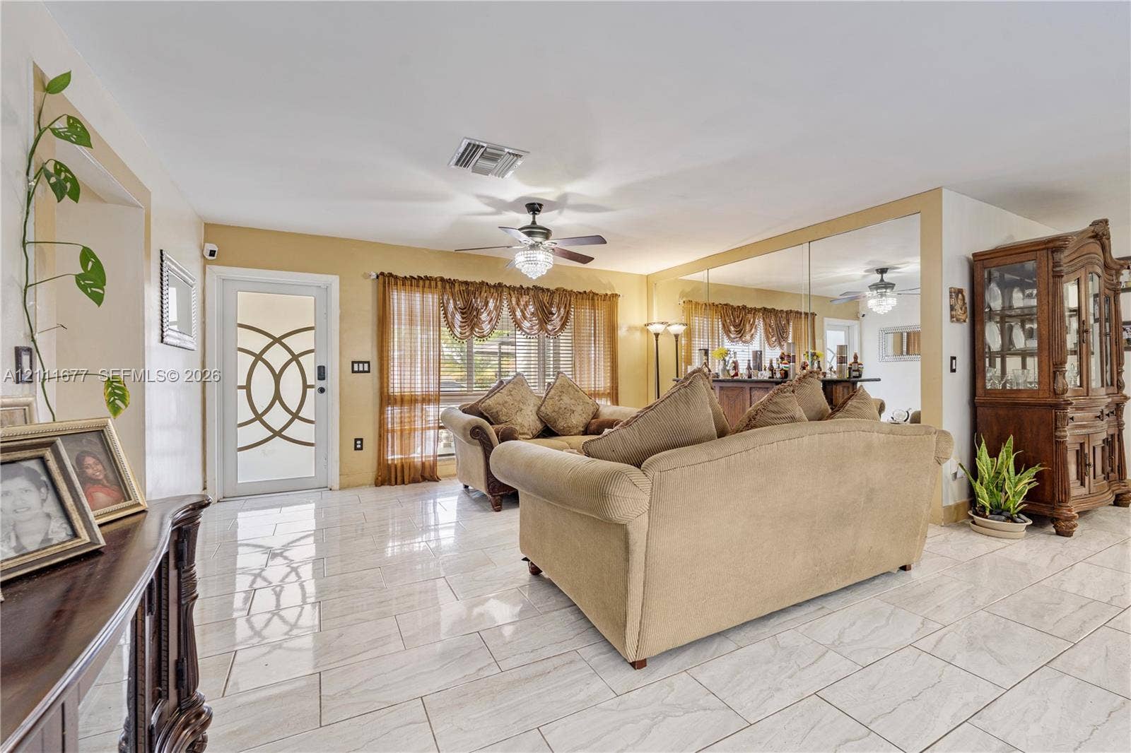 1921 Acapulco Drive, Miramar, FL 33023 Ceramic tile flooring, mirrored wall paneling, and an exterior door with geometric glass inserts