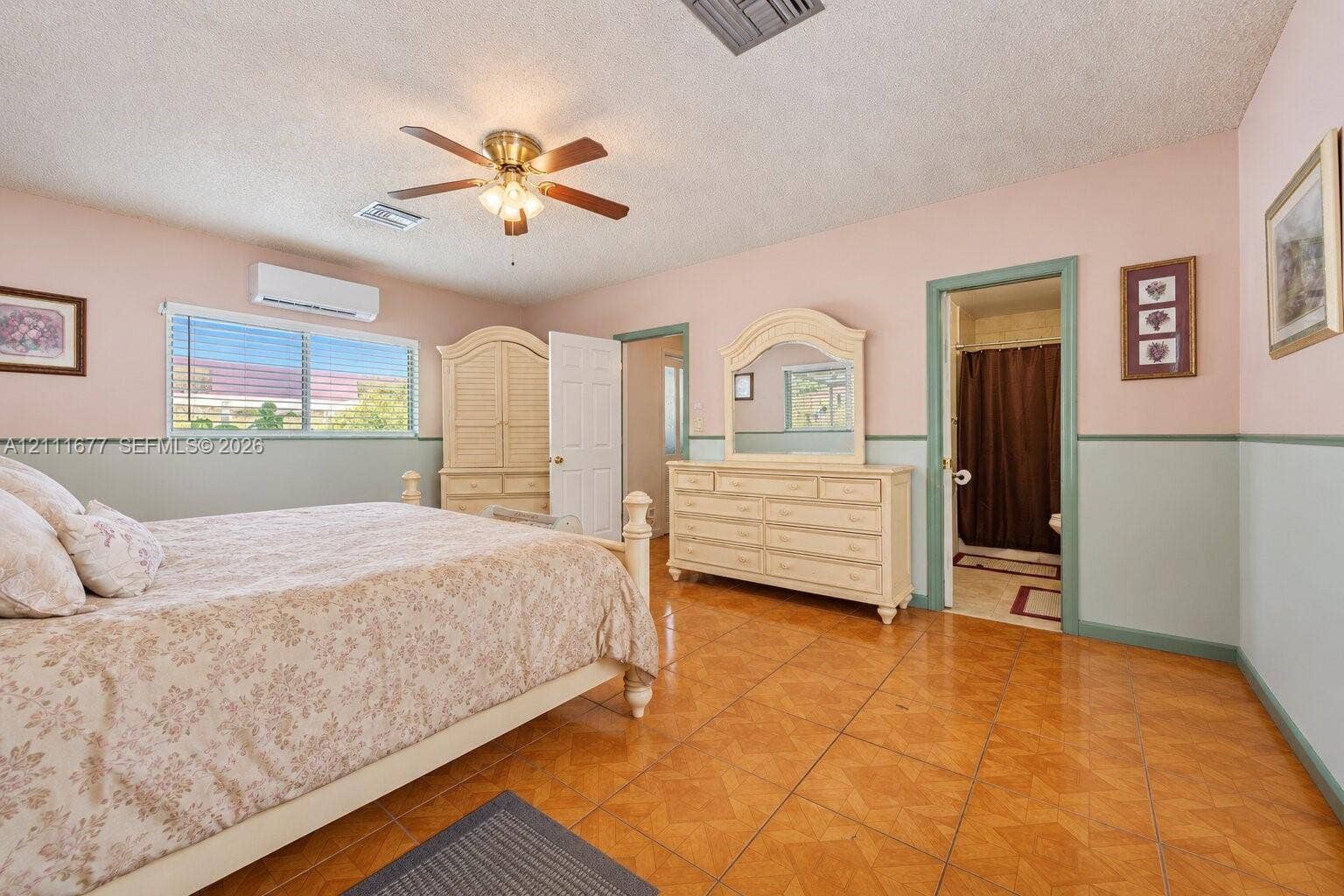 1921 Acapulco Drive, Miramar, FL 33023 Room featuring ceramic tile flooring, a wall-mounted mini-split HVAC unit, and a ceiling fan with integrated lighting