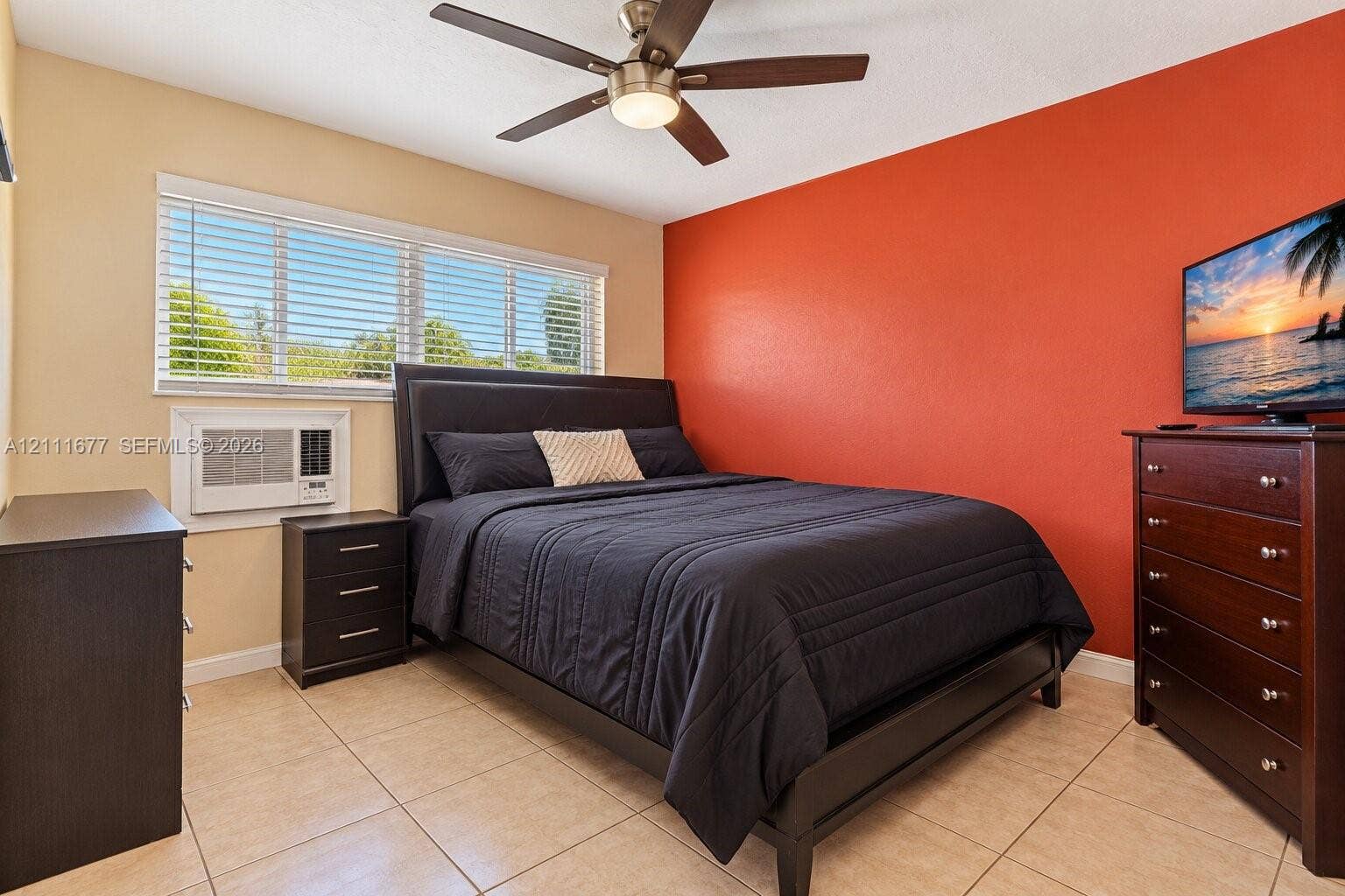 1921 Acapulco Drive, Miramar, FL 33023 Neutral-toned tile flooring, large windows with horizontal blinds, integrated air conditioning unit, and a ceiling fan with light fixture