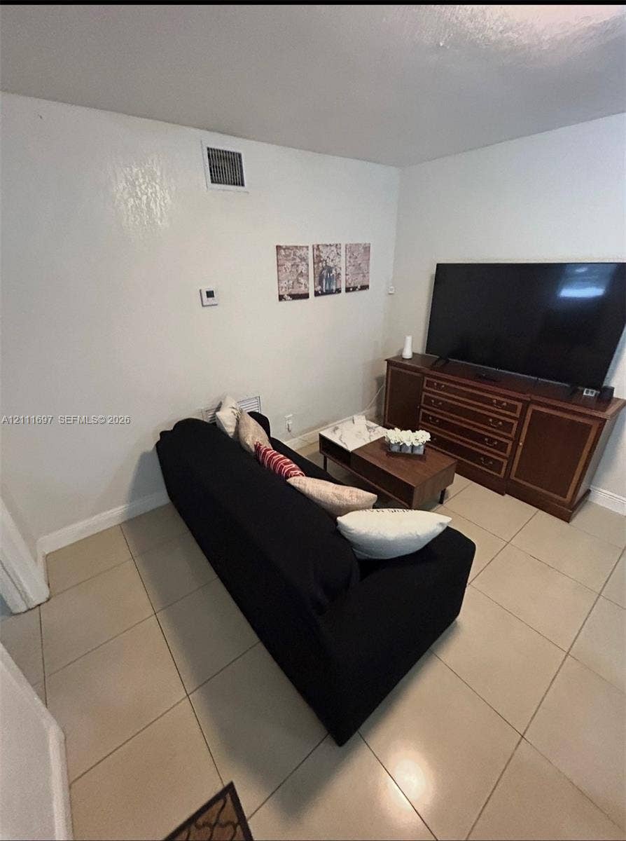 Large-format tile flooring throughout