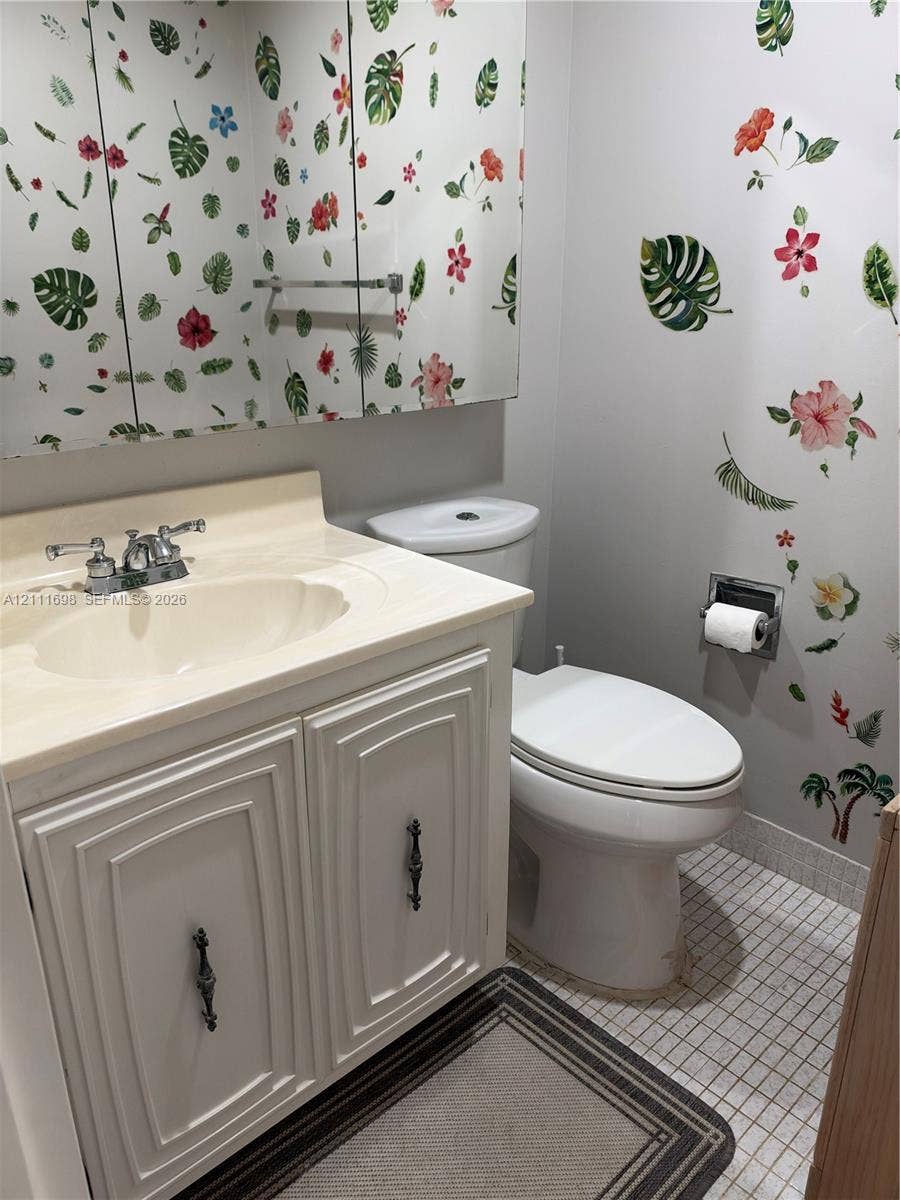 601 Three Islands Boulevard, #308, Hallandale Beach, Hallandale Beach, FL 33009 Bathroom featuring a vanity with integrated sink, chrome dual-handle faucet, mirrored medicine cabinet, and tiled flooring