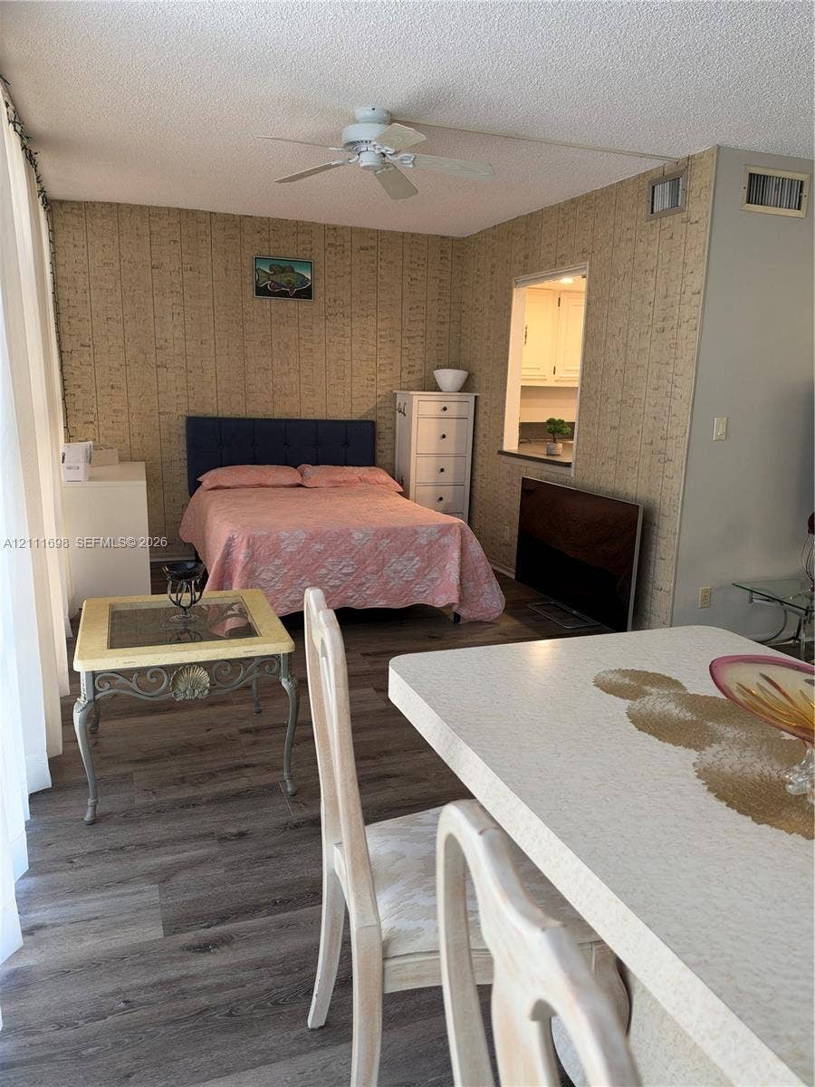 601 Three Islands Boulevard, #308, Hallandale Beach, Hallandale Beach, FL 33009 Wood-finish flooring, textured wallpaper, ceiling fan, and pass-through opening