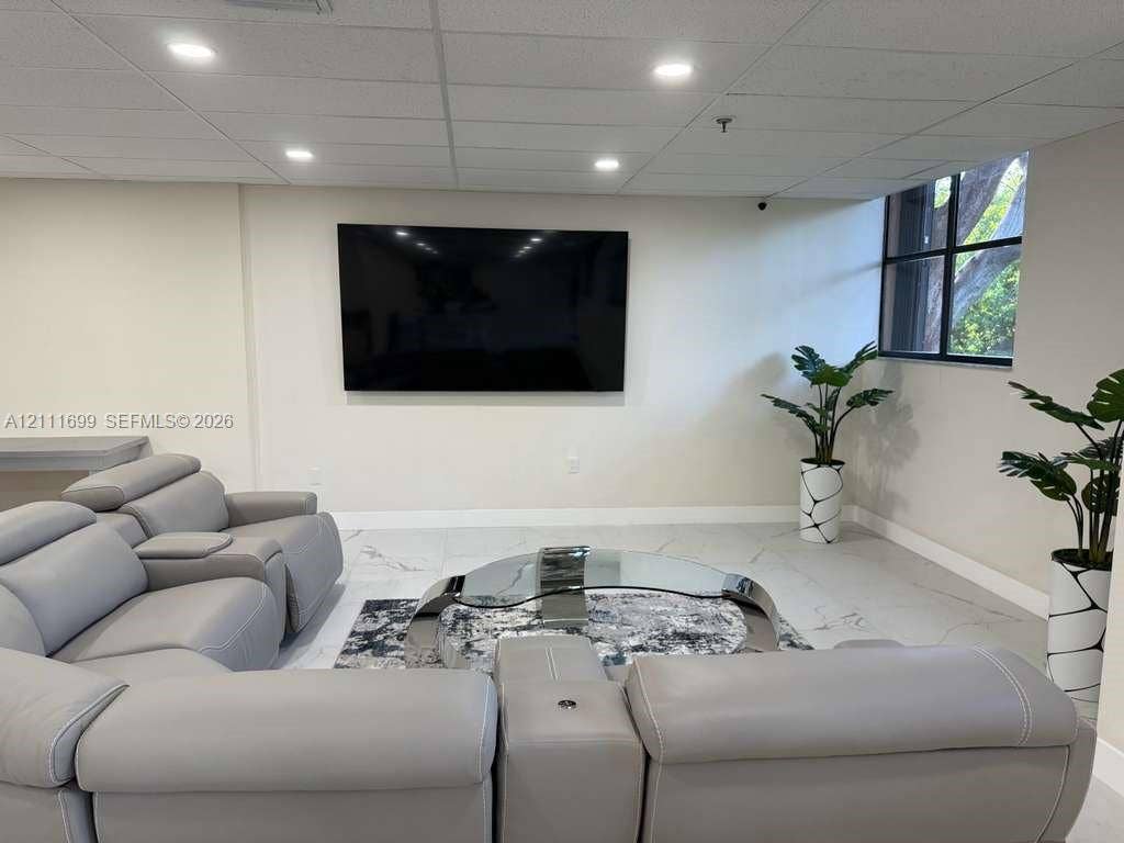 Large-format tile flooring, recessed ceiling lighting, and a multi-pane window