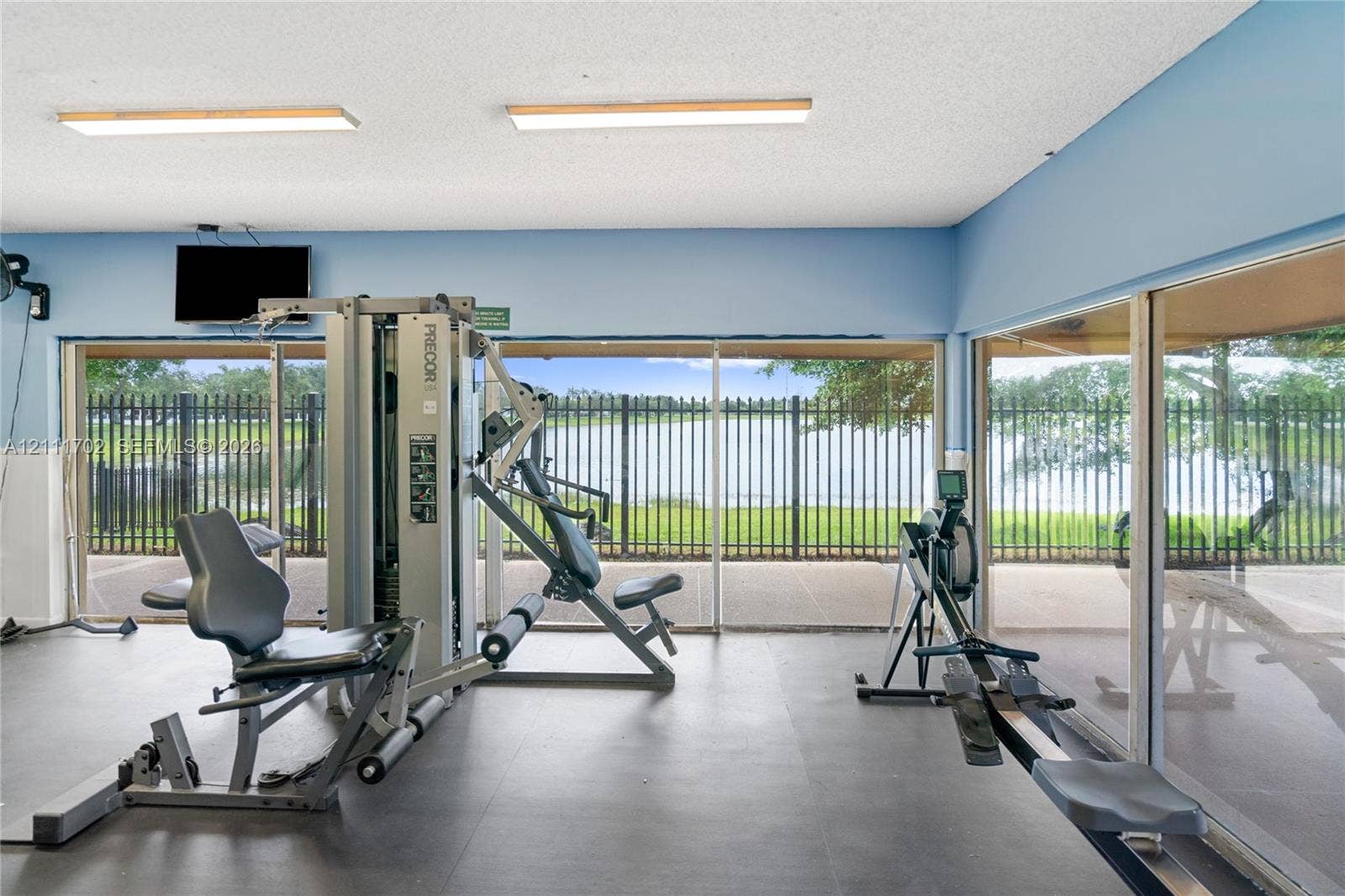 Fitness area featuring expansive floor-to-ceiling windows and solid-surface flooring