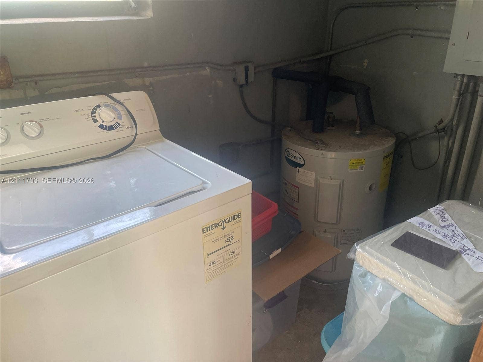 21840 SW 118th Avenue, Miami, FL 33170 Utility area featuring a top-load washer and a vertical water heater