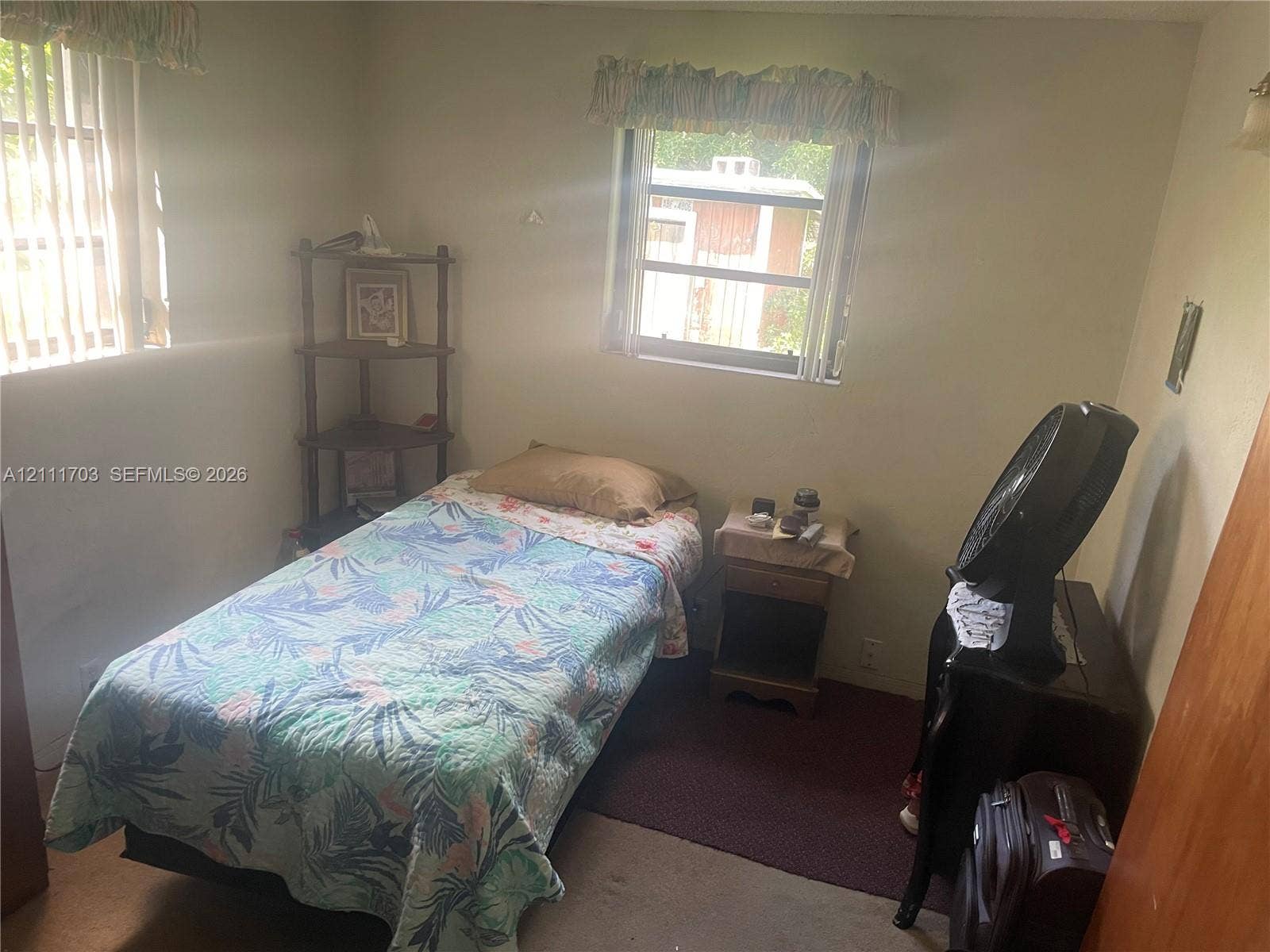 21840 SW 118th Avenue, Miami, FL 33170 Neutral-toned walls featuring dual windows with horizontal blinds and valances