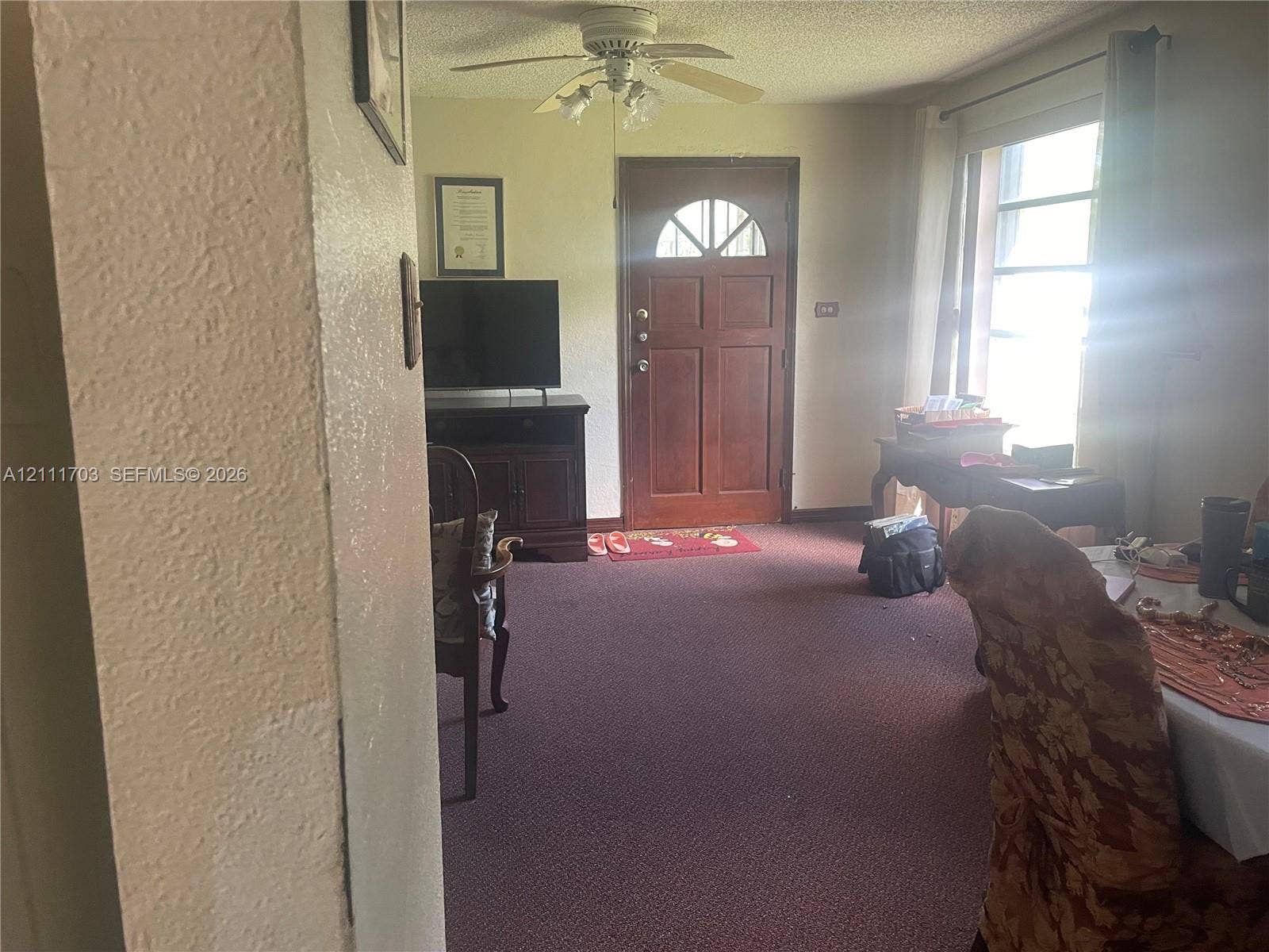 21840 SW 118th Avenue, Miami, FL 33170 Entry area featuring a solid wood door with a semi-circular glass insert, multi-pane window, and a ceiling-mounted light fixture with a fan