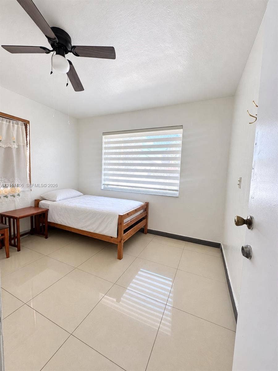2222 SW 19th Avenue, Miami, Miami, FL 33145 Large-format tile flooring, ceiling fan with integrated lighting, dual-layer window treatments, and white walls
