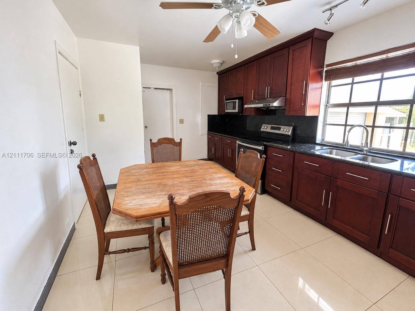 2222 SW 19th Avenue, Miami, Miami, FL 33145 Kitchen featuring cherry-finish cabinetry, dark stone countertops, stainless steel appliances, large-format tile flooring, and a multi-pane window