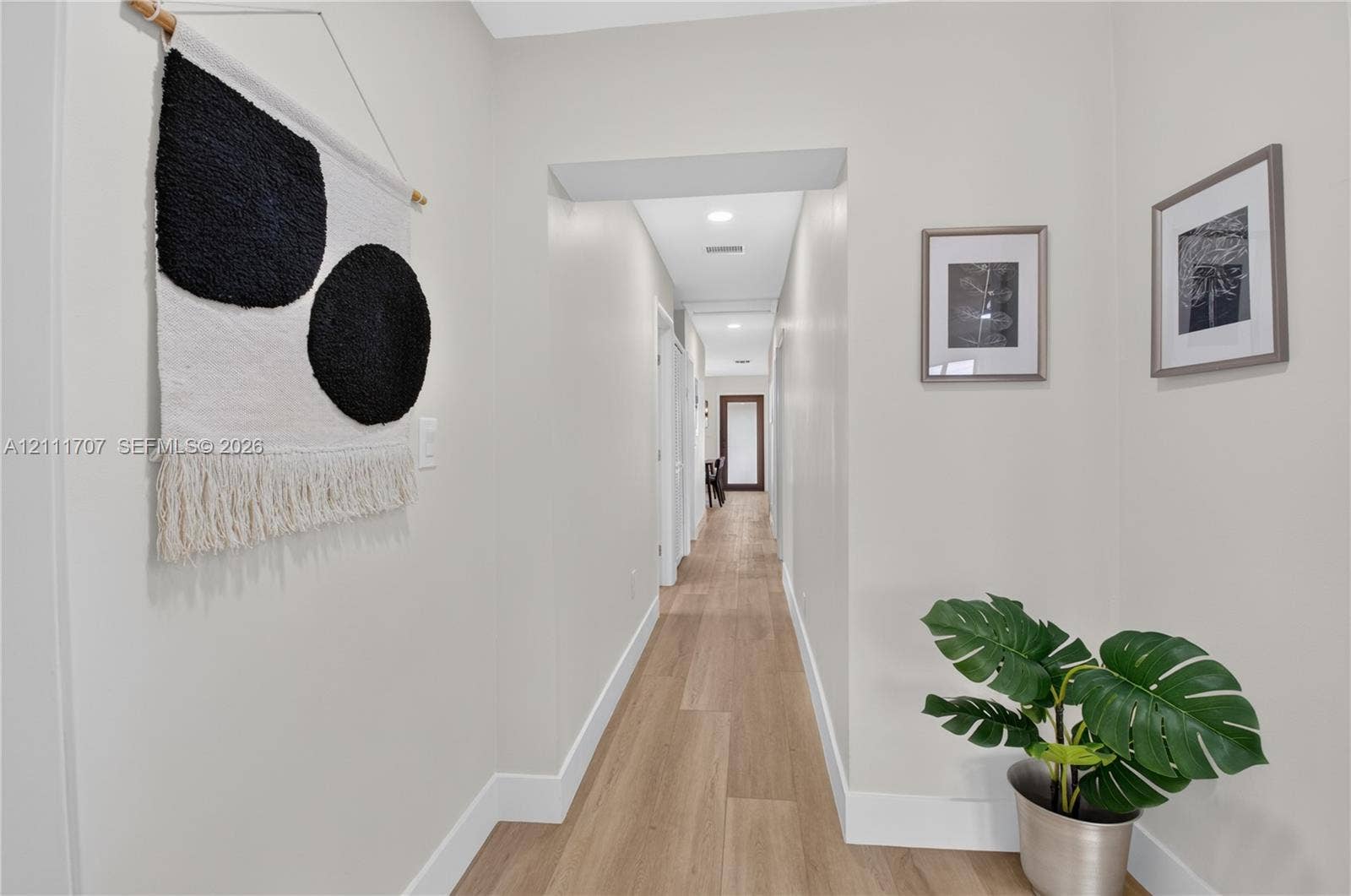 301 SW 12th Avenue, Delray Beach, FL 33444 Hallway featuring wood-finish flooring, recessed lighting, and neutral wall tones