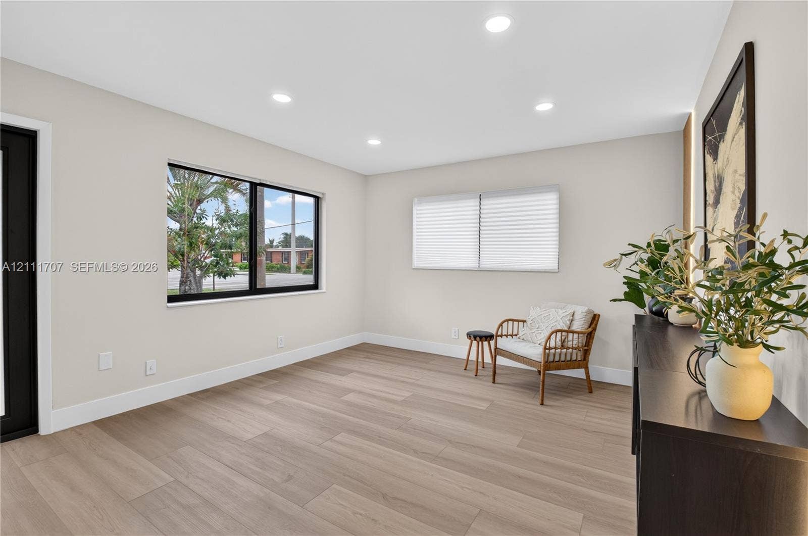 301 SW 12th Avenue, Delray Beach, FL 33444 Neutral-toned interior featuring wood-finish flooring, recessed lighting, and black-trimmed windows