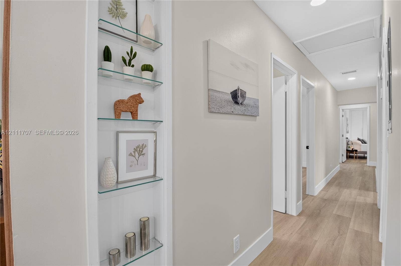 301 SW 12th Avenue, Delray Beach, FL 33444 Built-in recessed shelving with glass tiers and wood-finish flooring