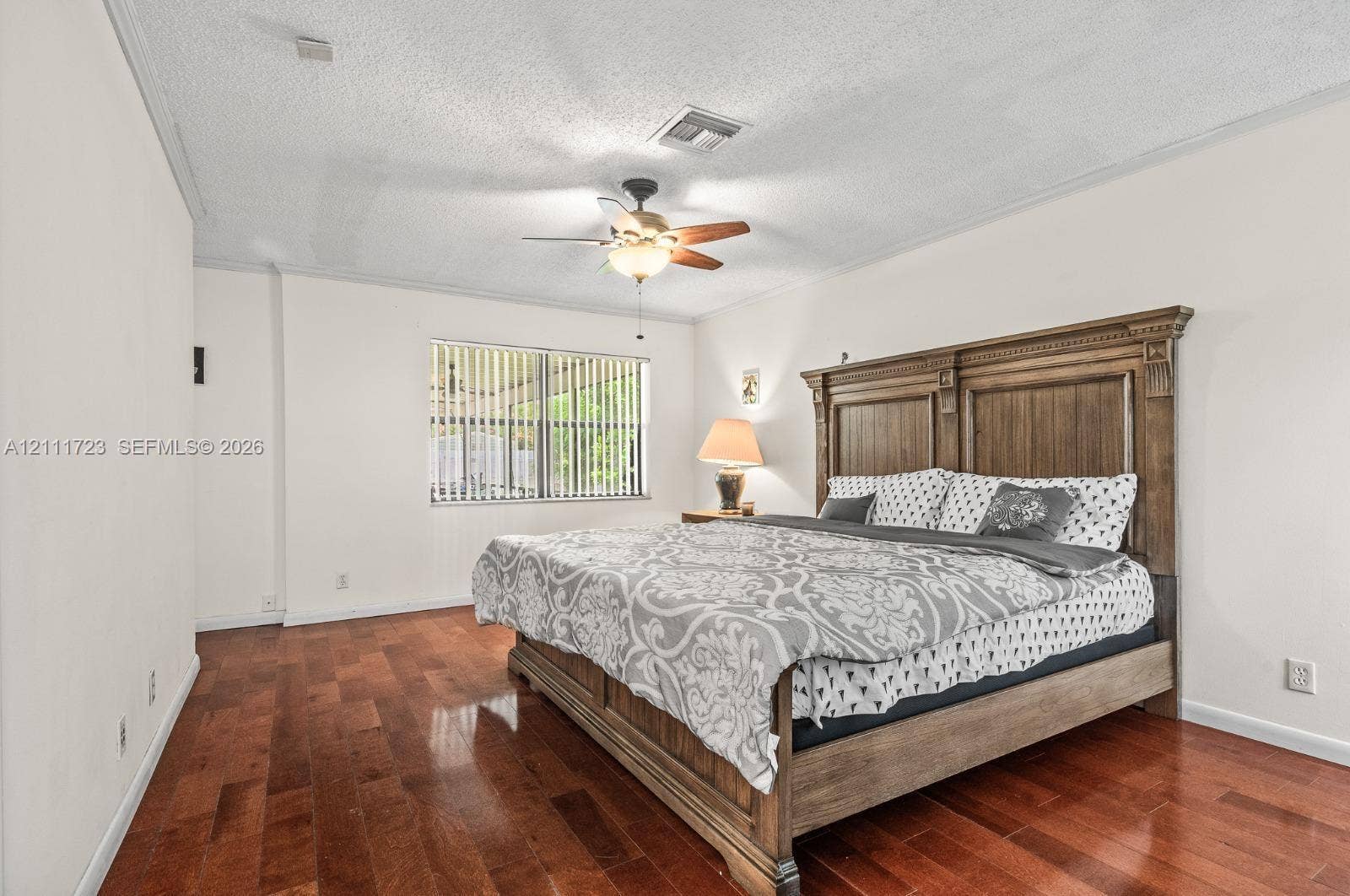 8541 NW 51st Court, Lauderhill, FL 33351 Interior space featuring wood-finish flooring, a ceiling fan with integrated light fixture, and horizontal window blinds