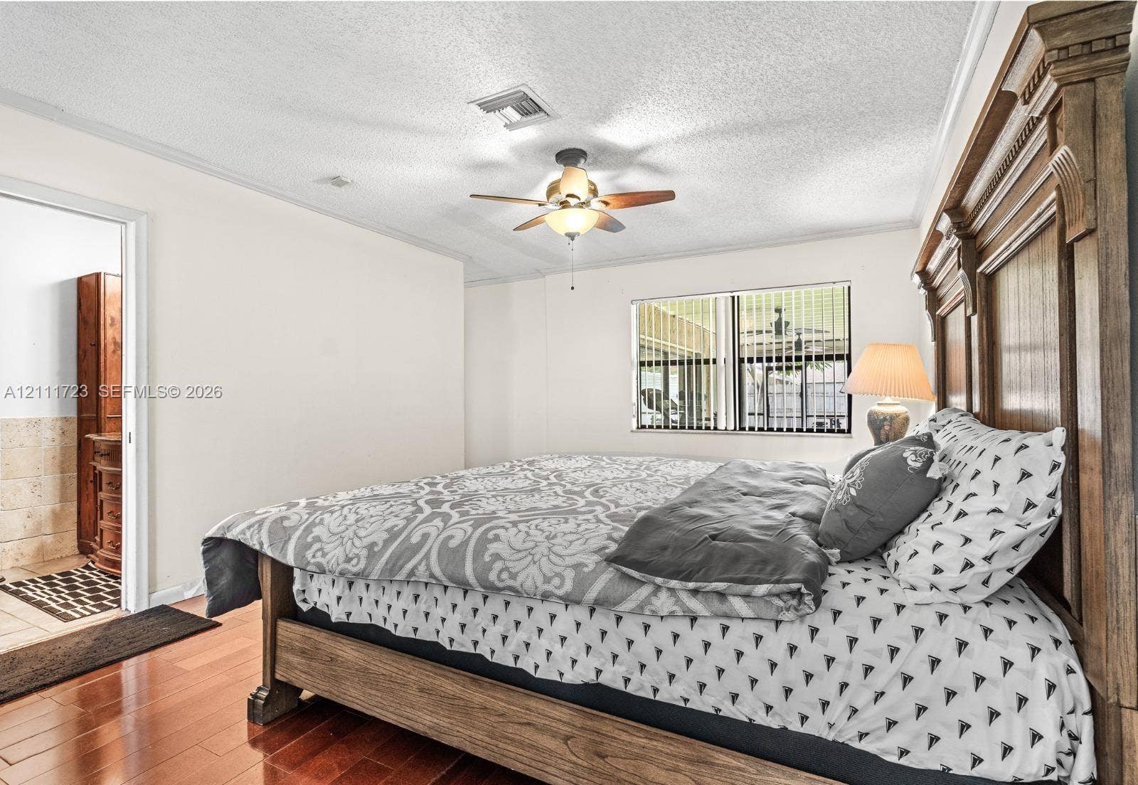 8541 NW 51st Court, Lauderhill, FL 33351 Wood-finish flooring, ceiling fan with integrated lighting, and horizontal window blinds