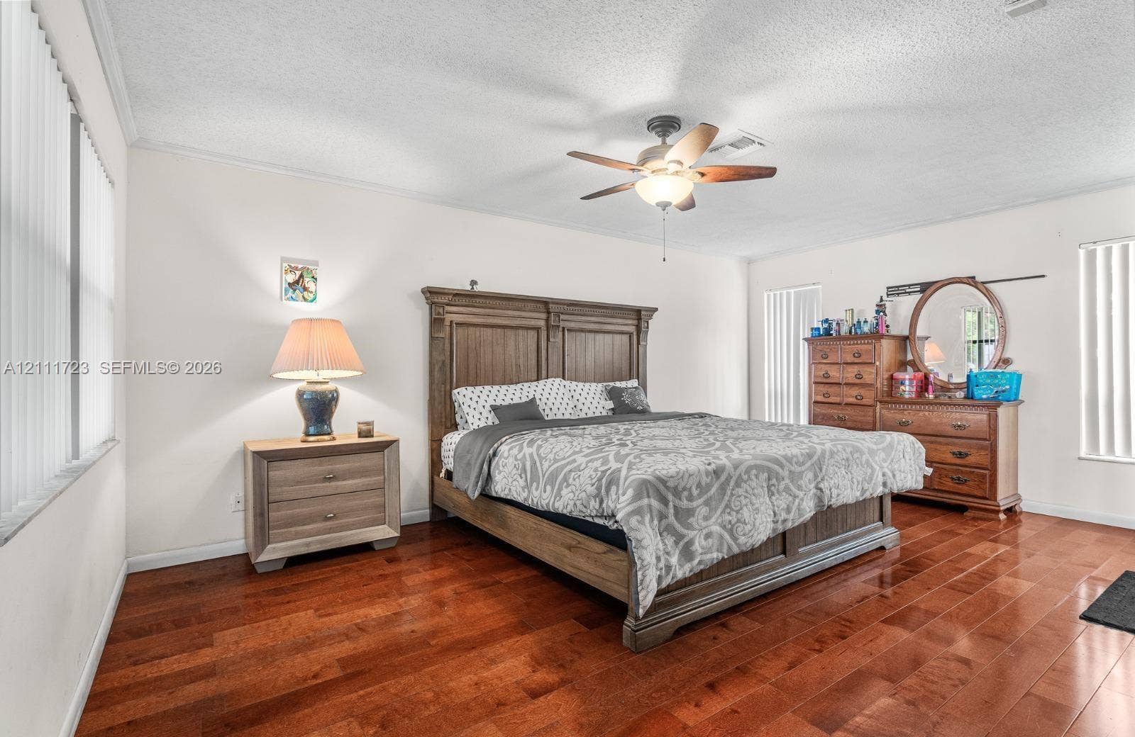8541 NW 51st Court, Lauderhill, FL 33351 Wood-finish flooring, ceiling fan with integrated light fixture, and vertical blinds
