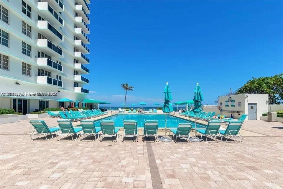 3725 S Ocean Drive, #508, Hollywood, Hollywood, FL 33019 Outdoor swimming pool surrounded by a paved deck featuring a high-rise residential structure